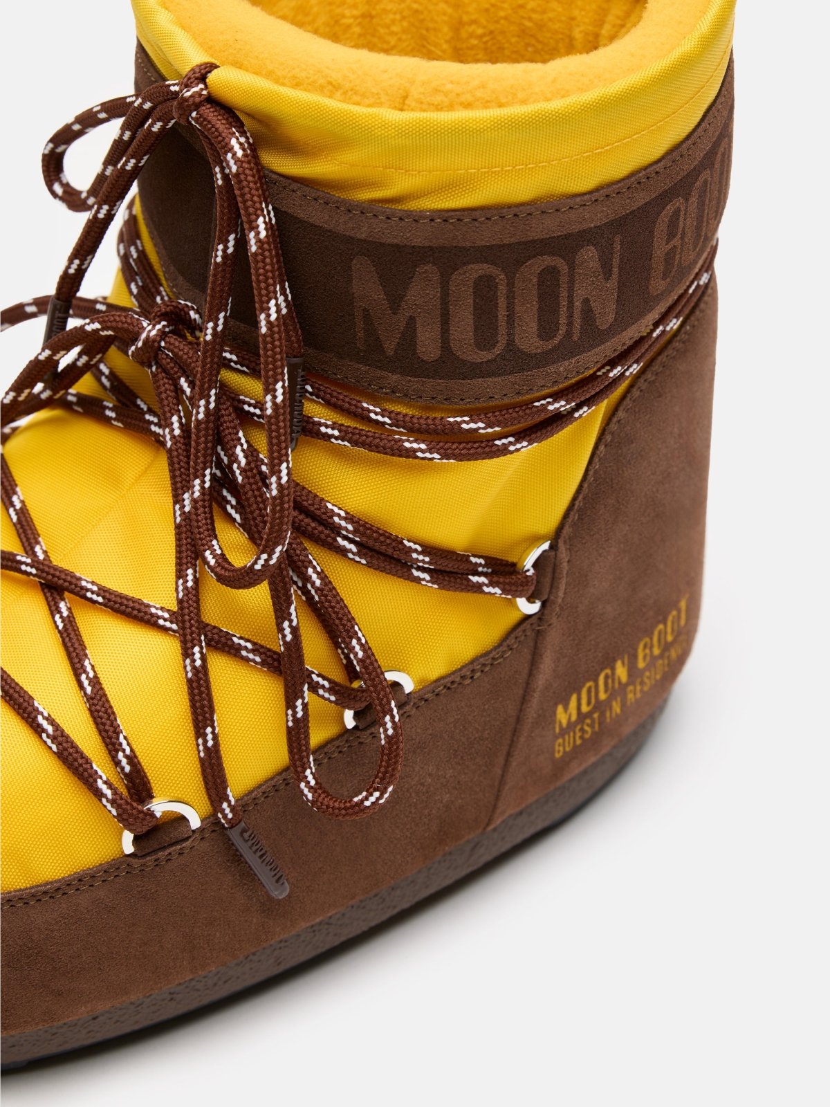 Close-up of yellow and brown MB X GIR ICON LOW NYLON boot with reflective laces and soft inner lining details