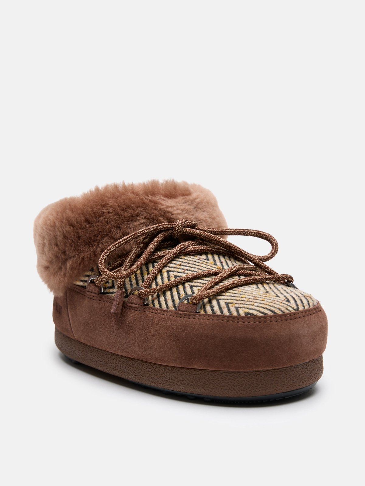 Brown fur-lined chalet mule with patterned fabric upper and thick sole, designed for cozy indoor and outdoor wear.