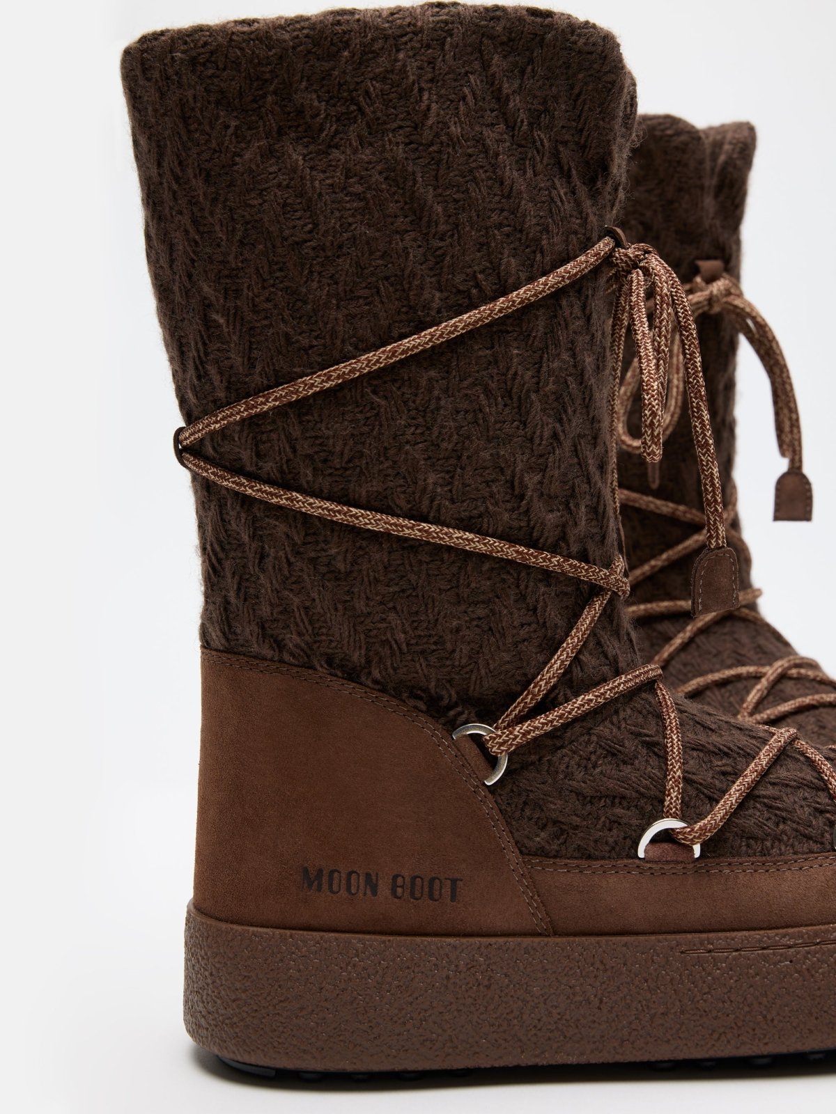 Close-up of brown MB X GIR LTRACK KNIT winter boots with textured knit upper and lace-up detail