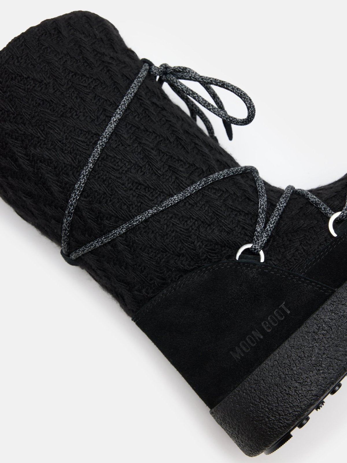 Close-up of black MB X GIR LTRACK KNIT boot with textured knit upper and lace-up detail on white background