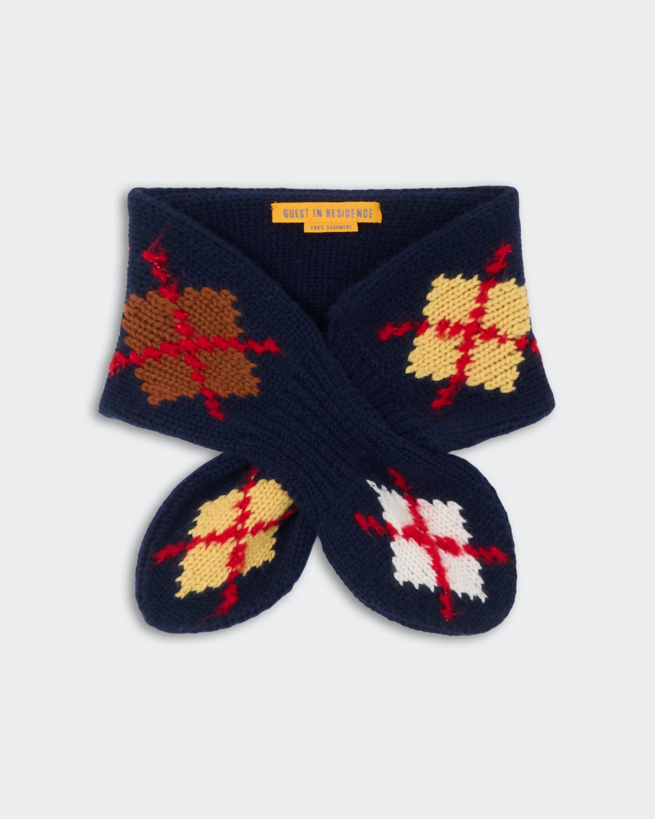 Argyle Bowtie Scarf - Midnight Combo featuring a knitted navy blue design with multicolor argyle patterns in brown, cream, yellow, red, and white accents.
