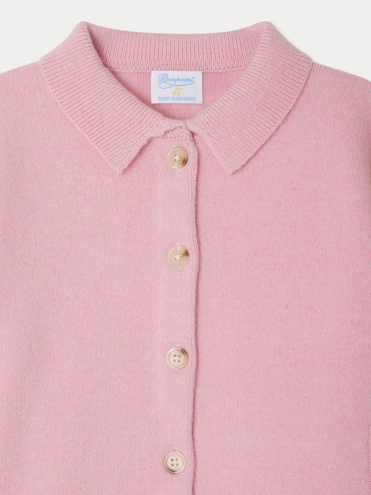 Close-up of pink LIBERTE JACKET made from 100% certified cashmere with round neck and button closure