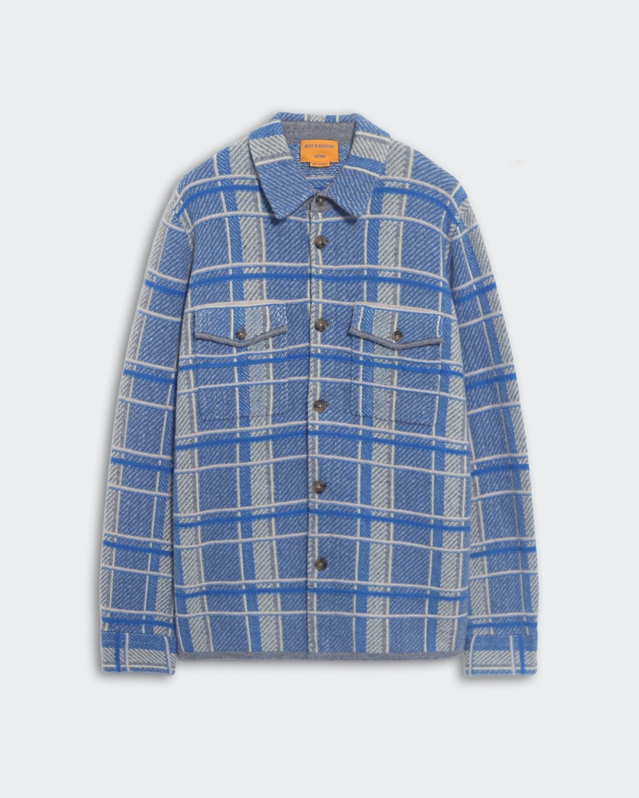 Blue and gray plaid work shirt with front button closure and chest patch pockets laid flat on white background