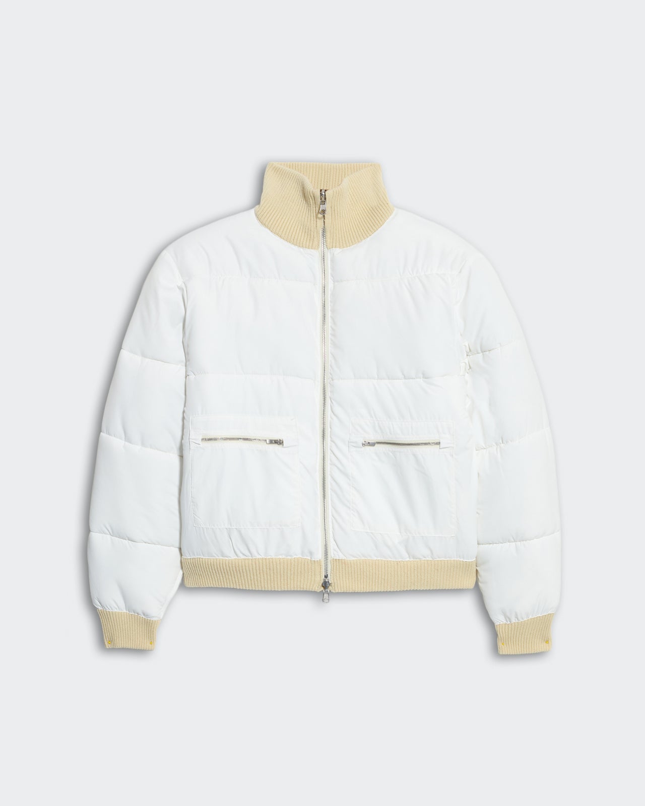 White quilted puffer jacket with beige ribbed collar, hem, cuffs, front zip, and zippered side pockets for women.