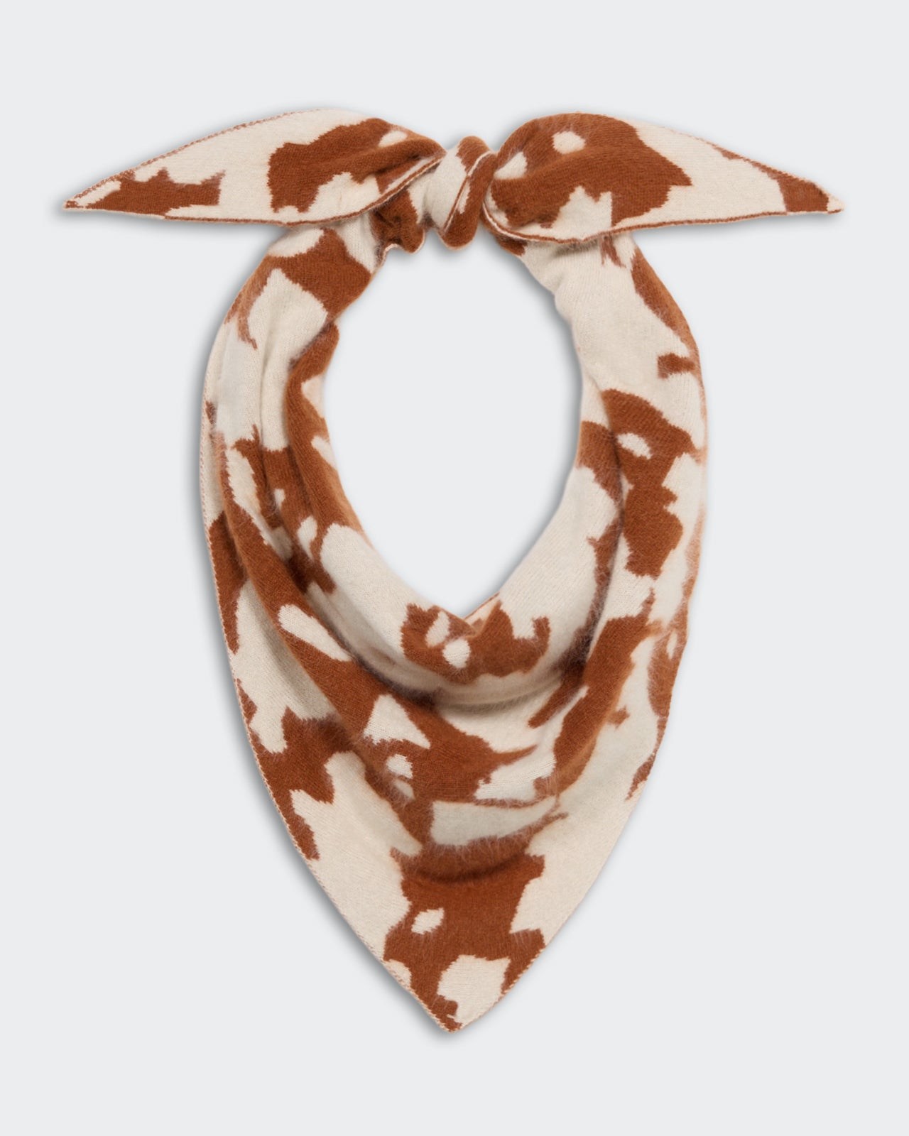 Grizzly Cowhide Wild Rag - Cream/Burnt Sienna cashmere scarf with a cowhide pattern, designed for stylish and cozy wear, tied in a knot at the top.