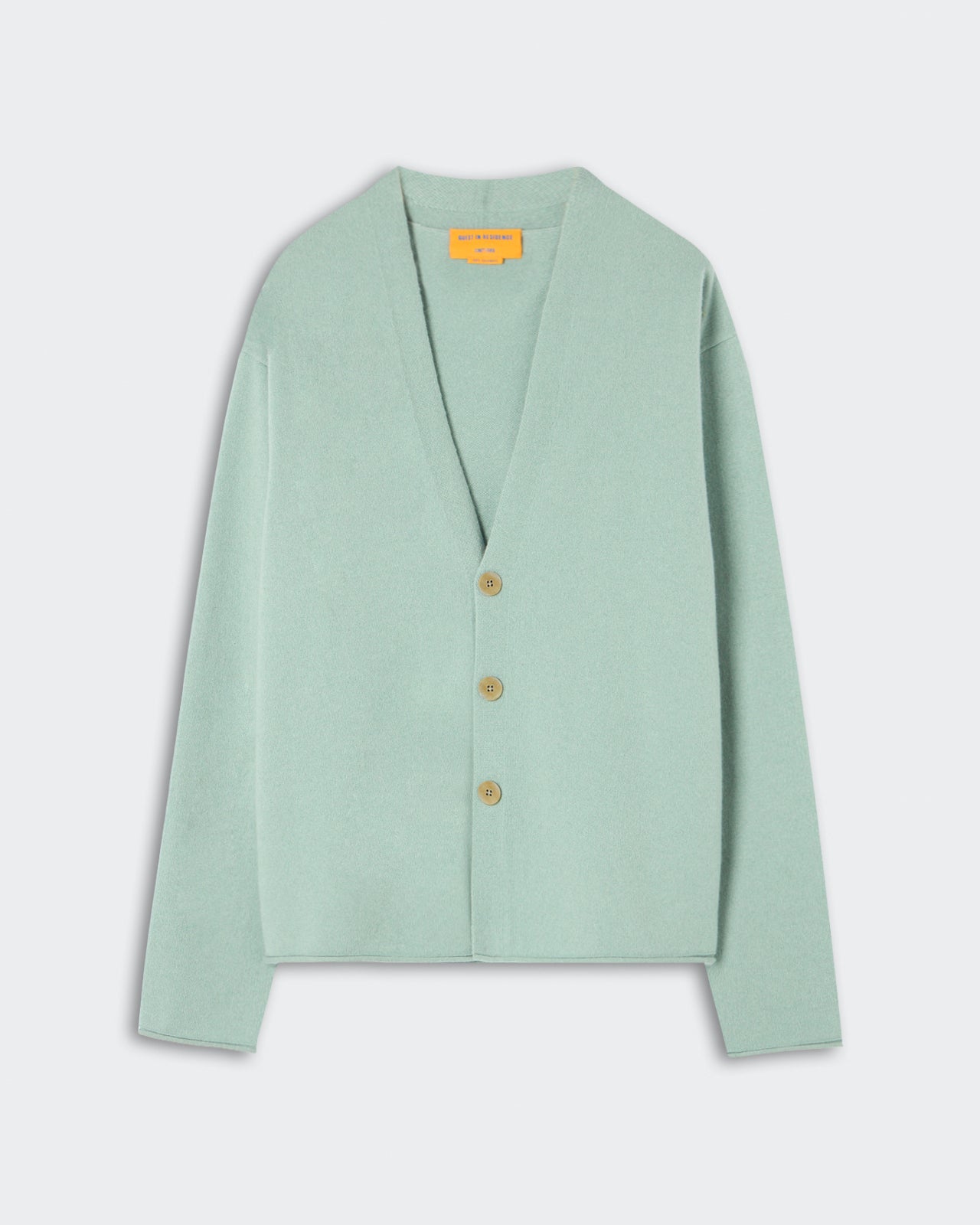 Everywear Cardigan - Sage Brush in a muted green shade, crafted from soft cashmere with a relaxed fit, deep V-neck, and three natural buttons for a minimalist closure.