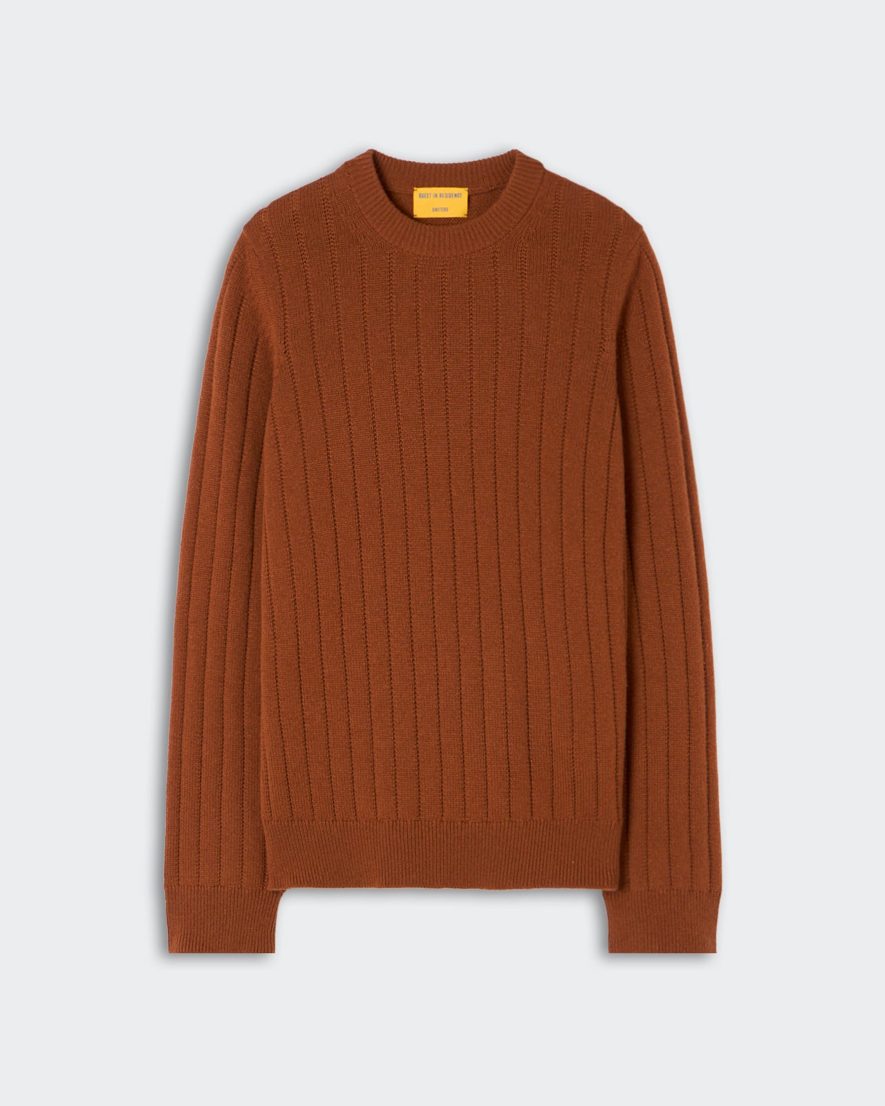 Rust-colored ribbed knit long sleeve sweater with crew neckline displayed on a light background.