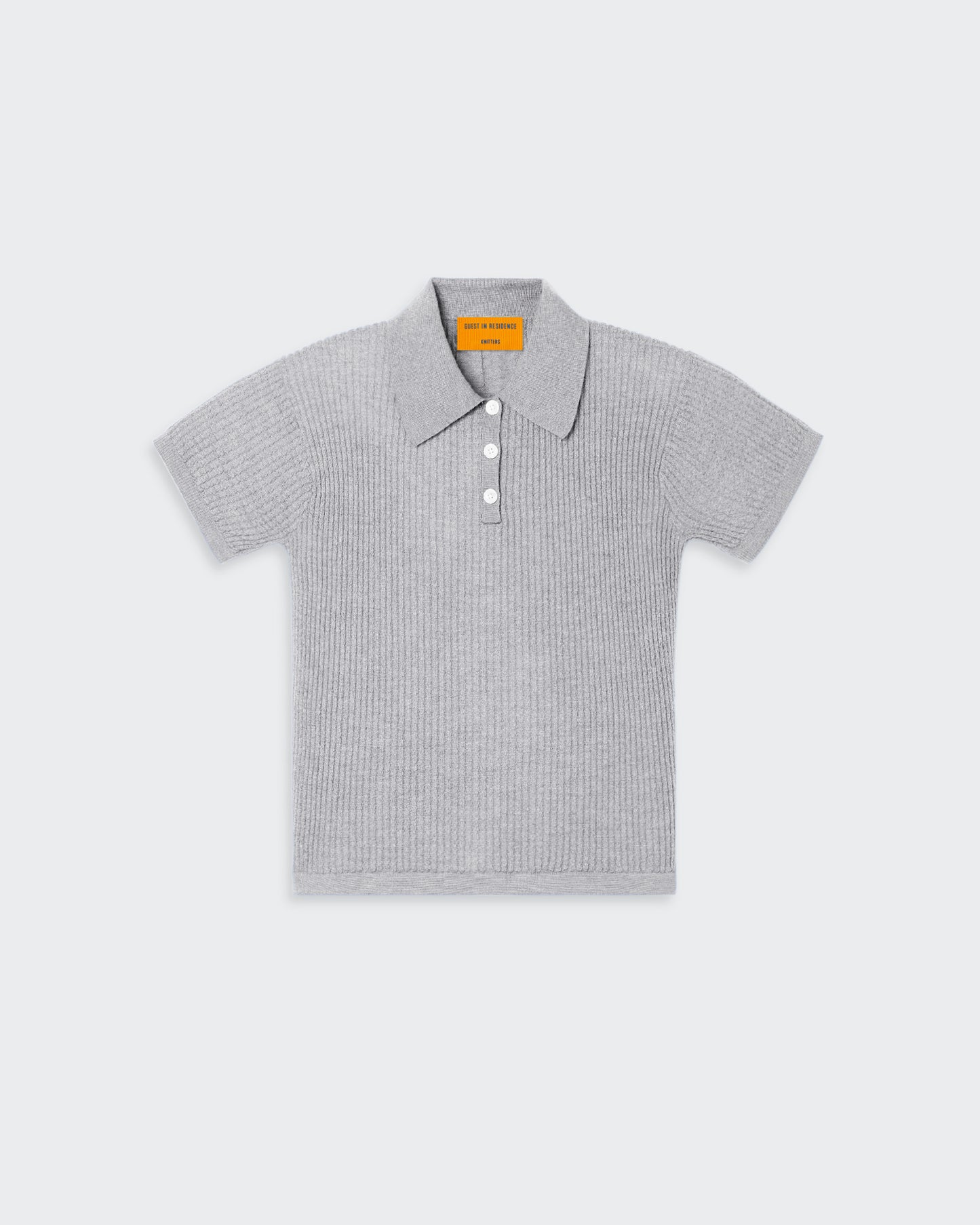 A grey women's polo shirt with a three-button front placket, textured waffle stitch, and signature branding at the center back neck.