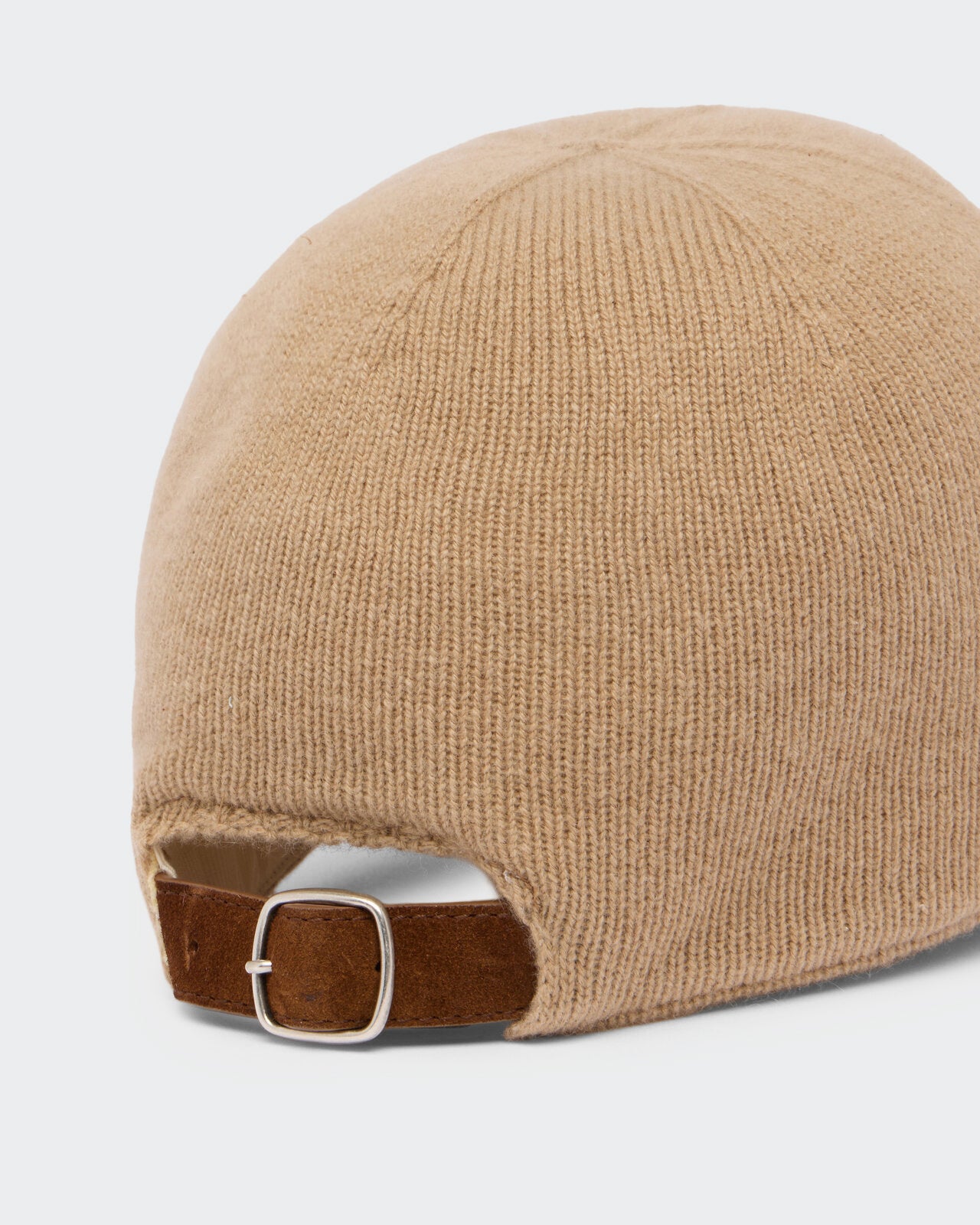 The Baseball Cap - Camel/Butter showing a close-up of the back with camel-colored knit fabric and an adjustable brown suede strap with a silver buckle.