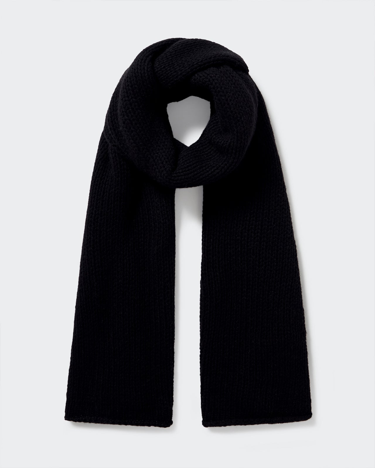The Blanket Scarf - Black made of lightweight 100% cashmere with a chunky open knit design.