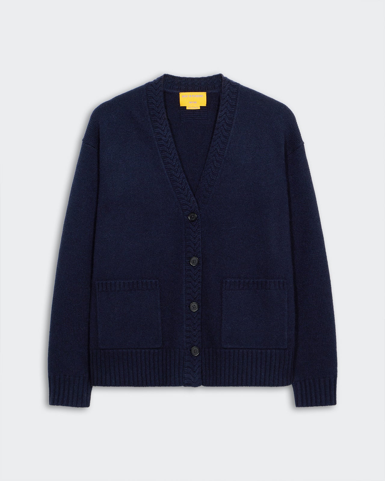 The Cardigan - Midnight in navy cashmere with five-button closure, ribbed trim, and two front patch pockets.