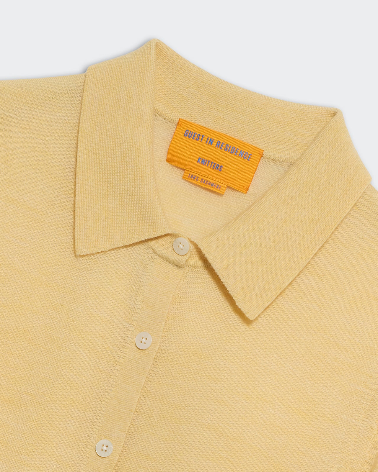 Elle Shirt in Cashmere Butter close-up showing shirt collar, buttons, and premium lightweight knit fabric.