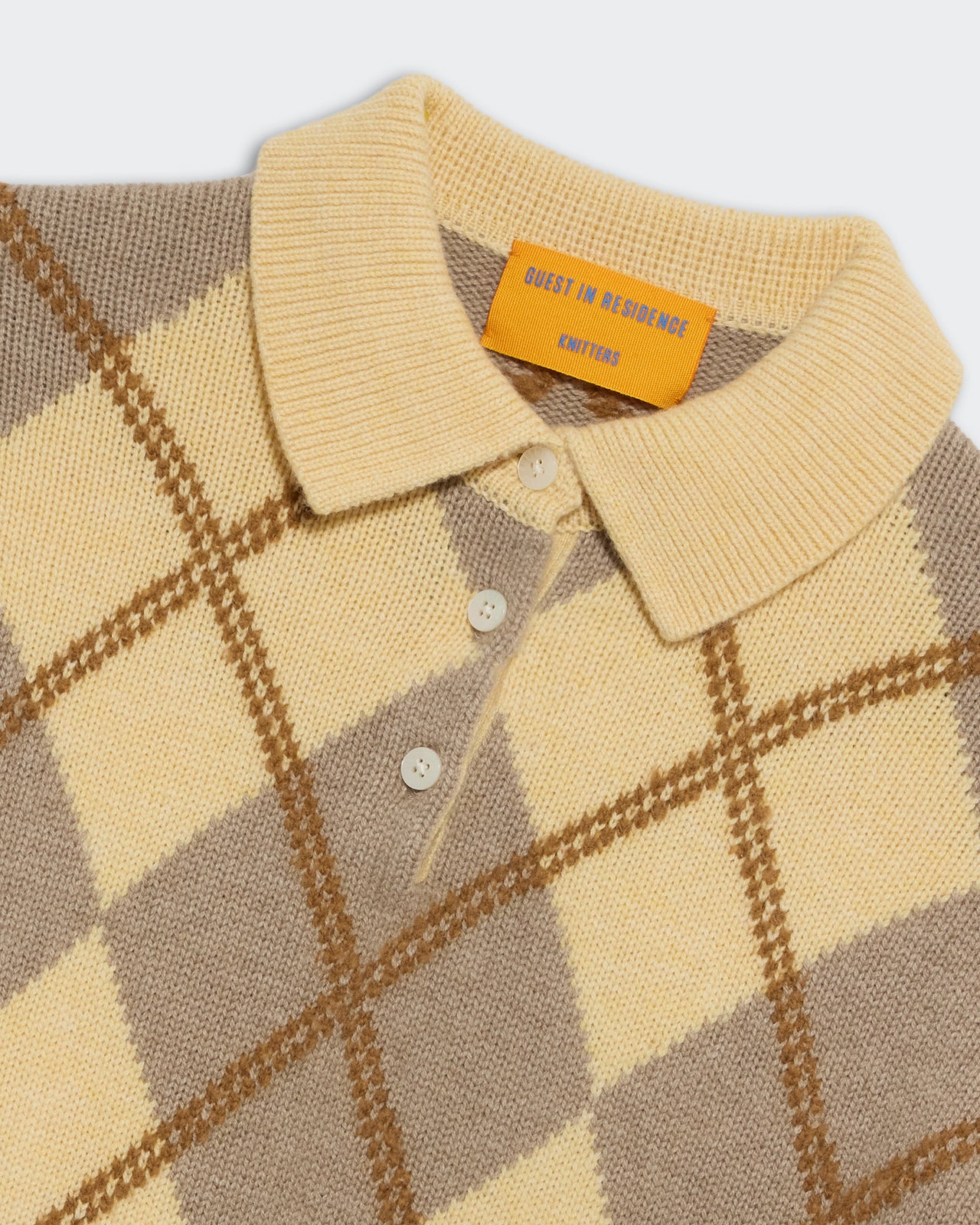 Collegiate Argyle Polo - Butter Combo featuring a soft knit fabric with beige, yellow, and brown argyle pattern and button collar.