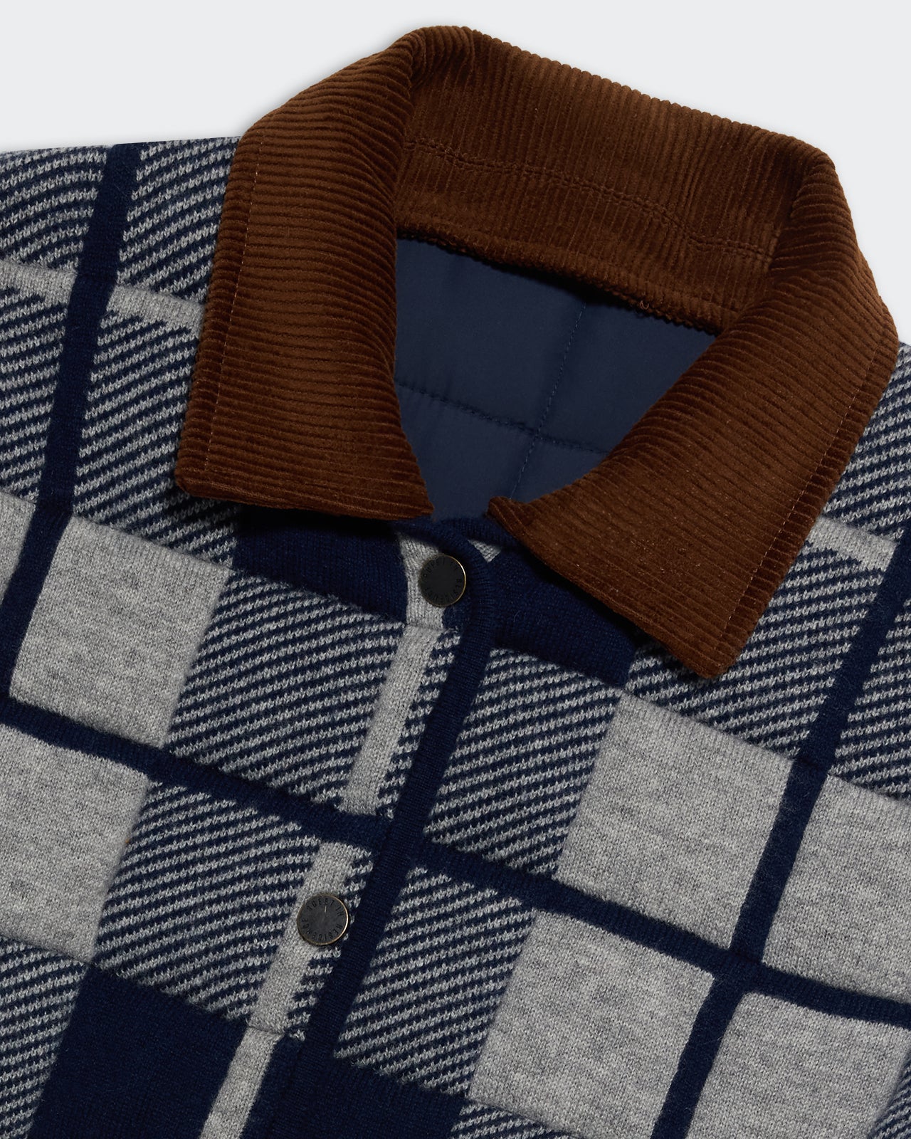 Close-up of brown collar and plaid pattern on Quilted Plaid Liner Jacket - Midnight Combo with snap buttons and navy lining