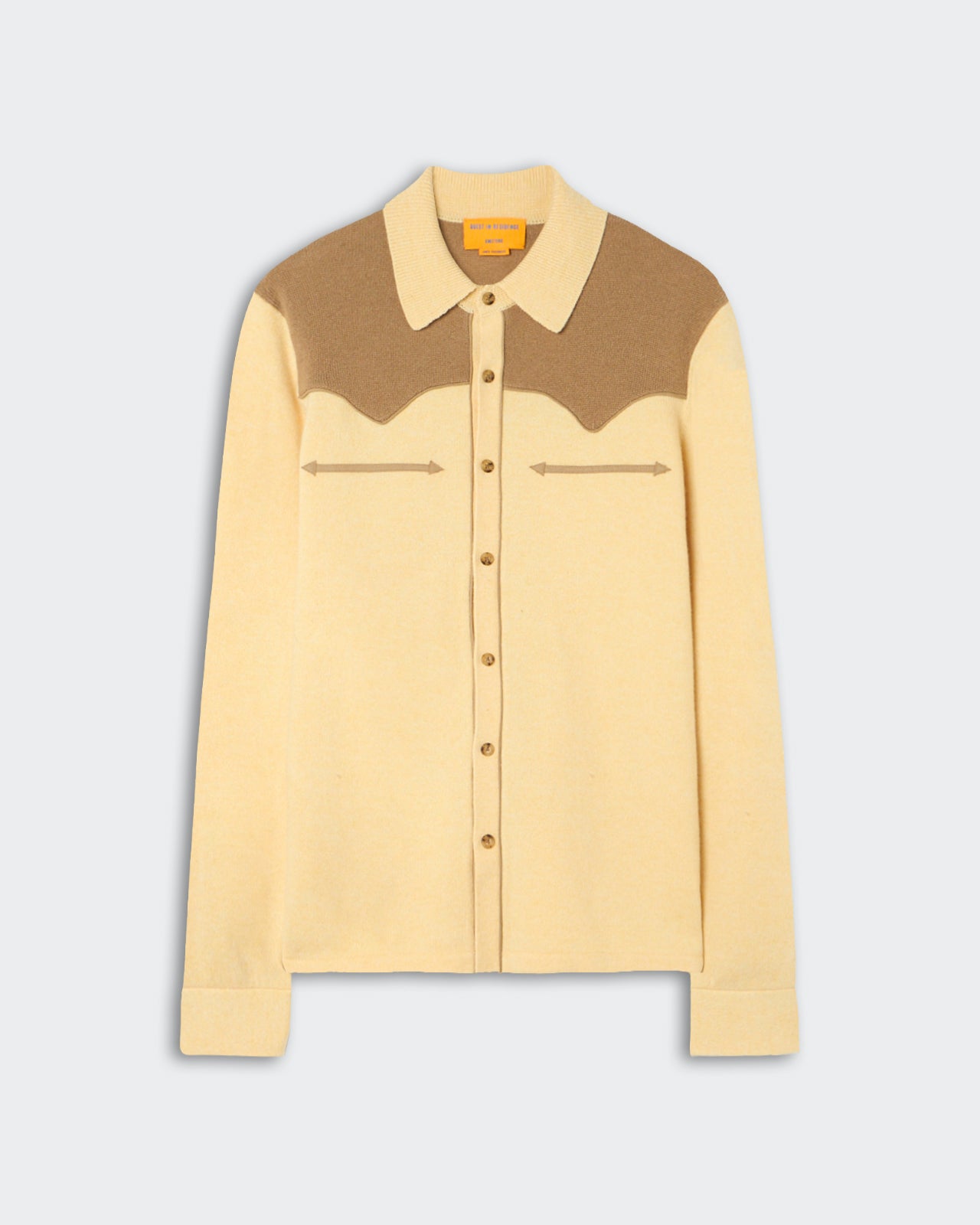 Long-sleeve button-up cardigan with a pointed collar in beige and brown color blocking across the shoulders and upper chest, laid flat on a light background.