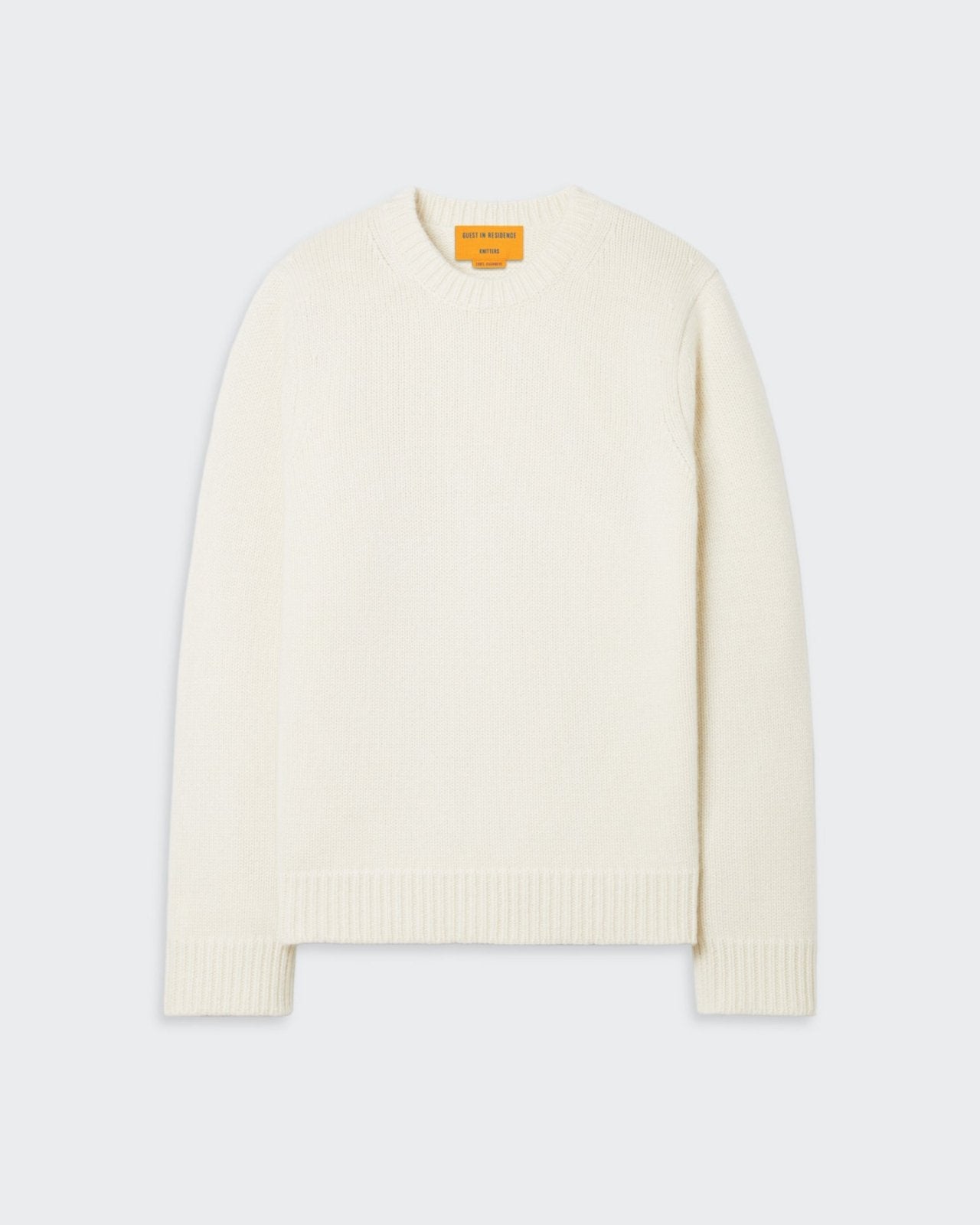 Cream-colored cashmere crew neck sweater with signature branding at the back.