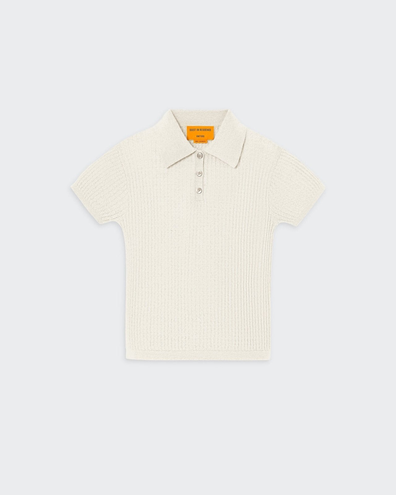 Beige women's cashmere polo shirt with a three-button front placket and textured waffle stitch pattern.