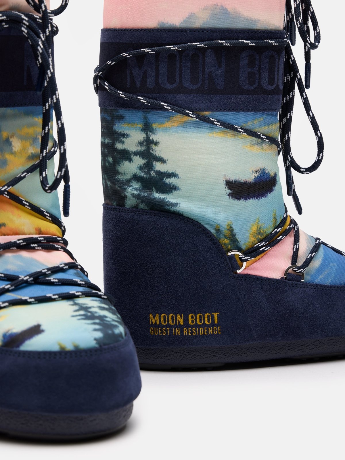 Close-up of Moon Boot X GIR ICON HIGH POSTCARD winter boots with colorful scenic print and navy blue details