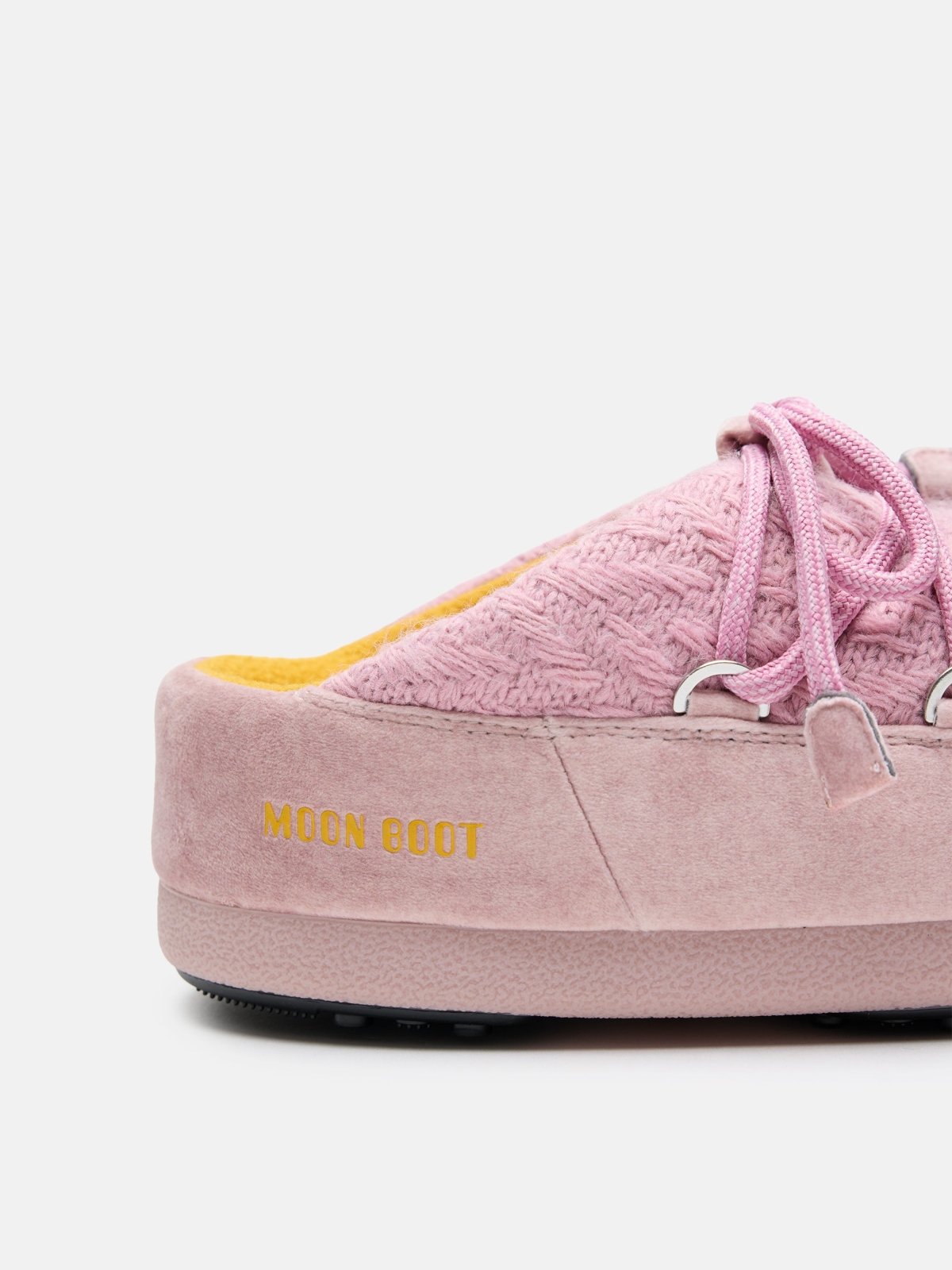 Close-up of pink MB X GIR EVX MULE KNIT shoe with textured knit upper, suede sole, and yellow MOON BOOT branding