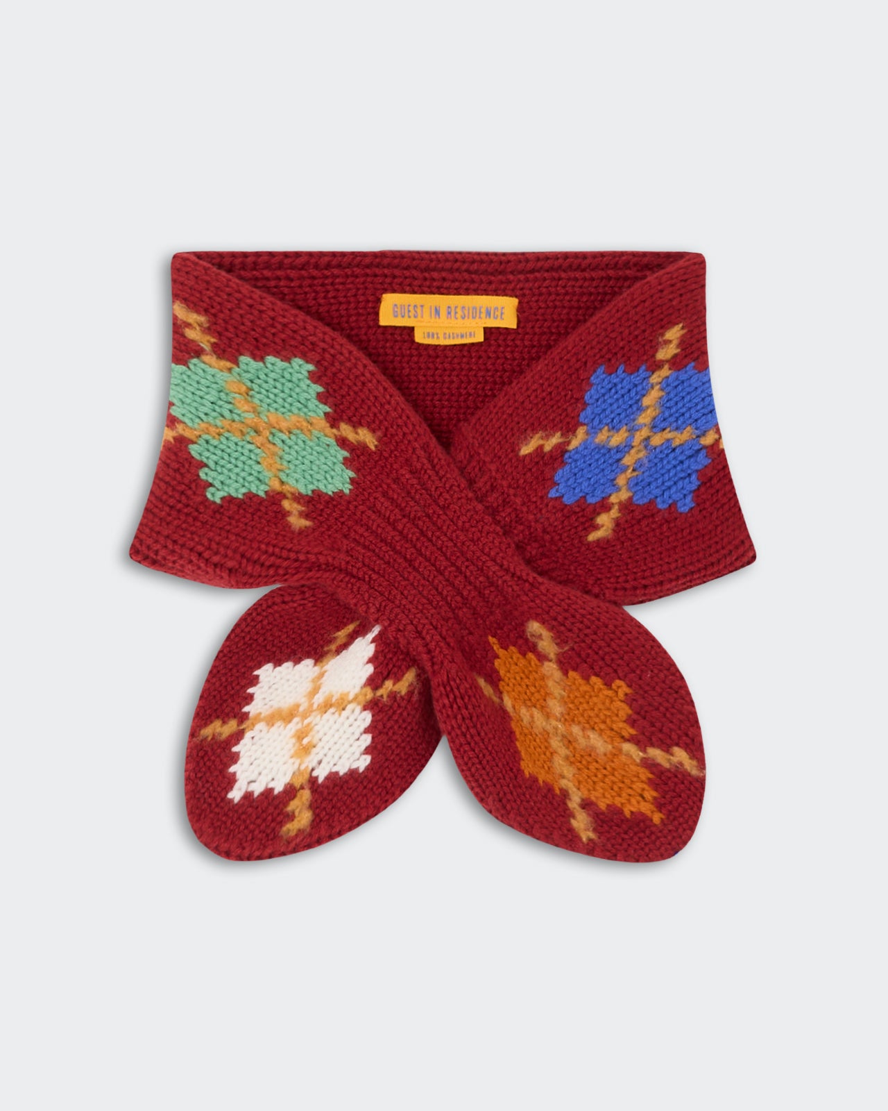 Argyle Bowtie Scarf - Carmine Combo featuring a rich red knit with multicolored argyle patterns in blue, green, white, and orange, designed for stylish warmth.