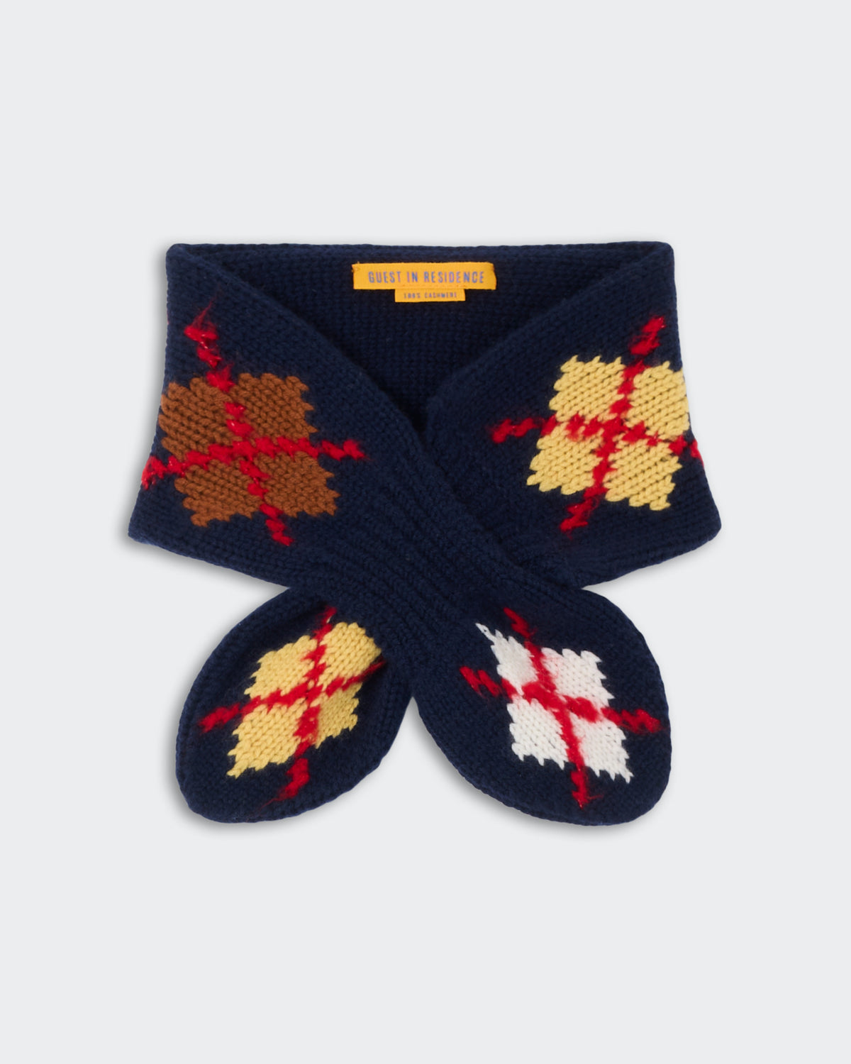 Argyle Bowtie Scarf - Midnight Combo featuring a knitted navy blue design with multicolor argyle patterns in brown, cream, yellow, red, and white accents.