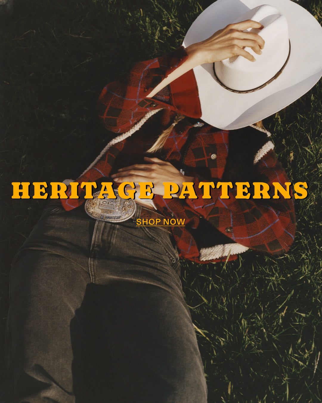 Person lying on grass in a red plaid cardigan and white cowboy hat with overlay text reading Heritage Patterns and Shop Now