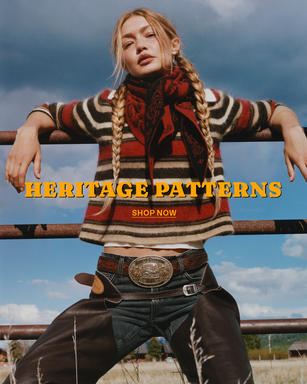 Woman with braided hair wearing a striped sweater and red scarf while leaning on a metal railing under a cloudy sky. Text reads Heritage Patterns and Shop Now