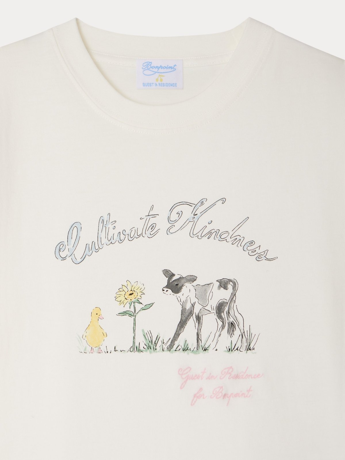 Close-up of a white organic cotton THIBALD T-shirt with a calf, duckling, sunflower, and "Cultivate Kindness" text design