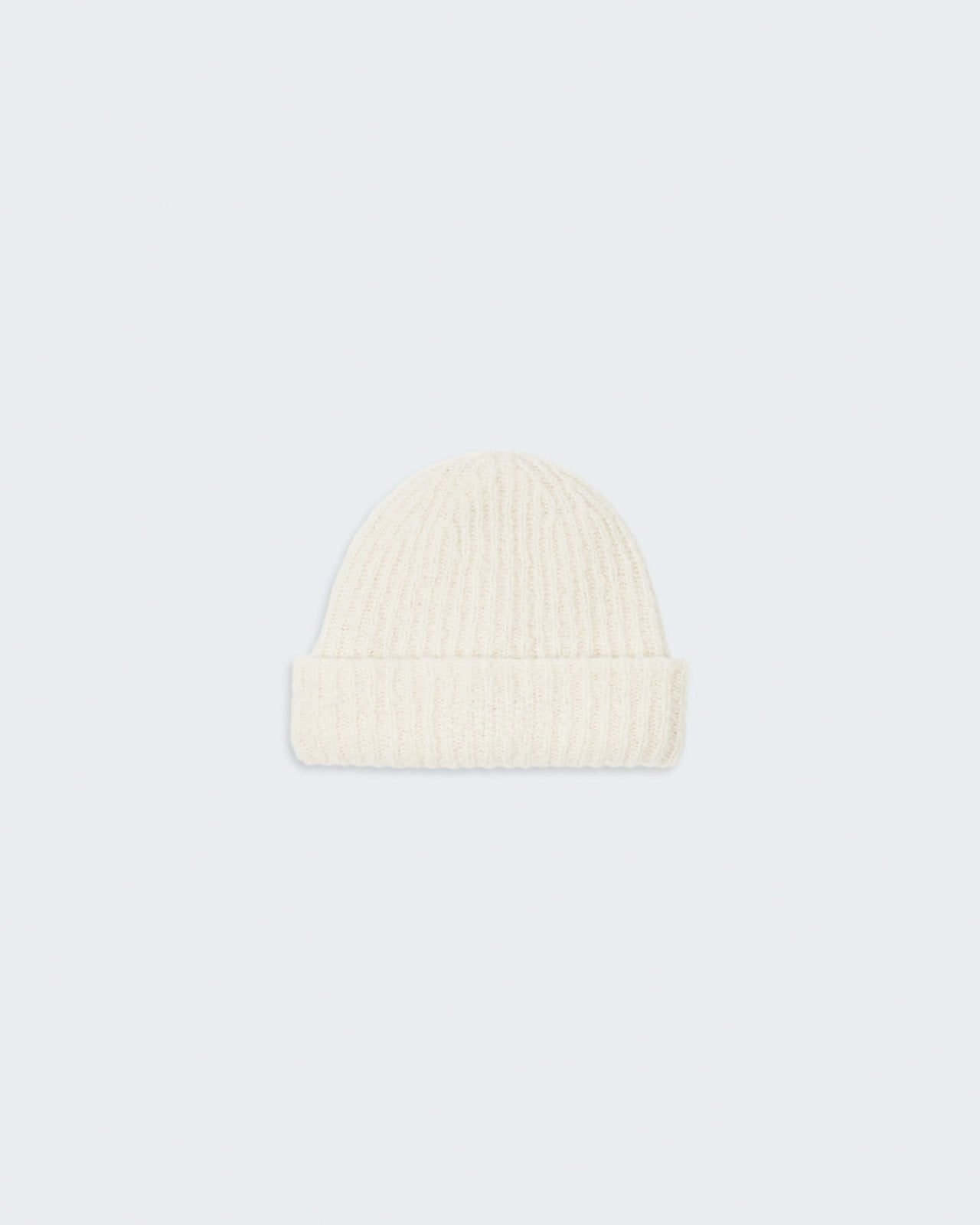 Cream-colored knitted beanie with a high cuff and the brand's signature trim.