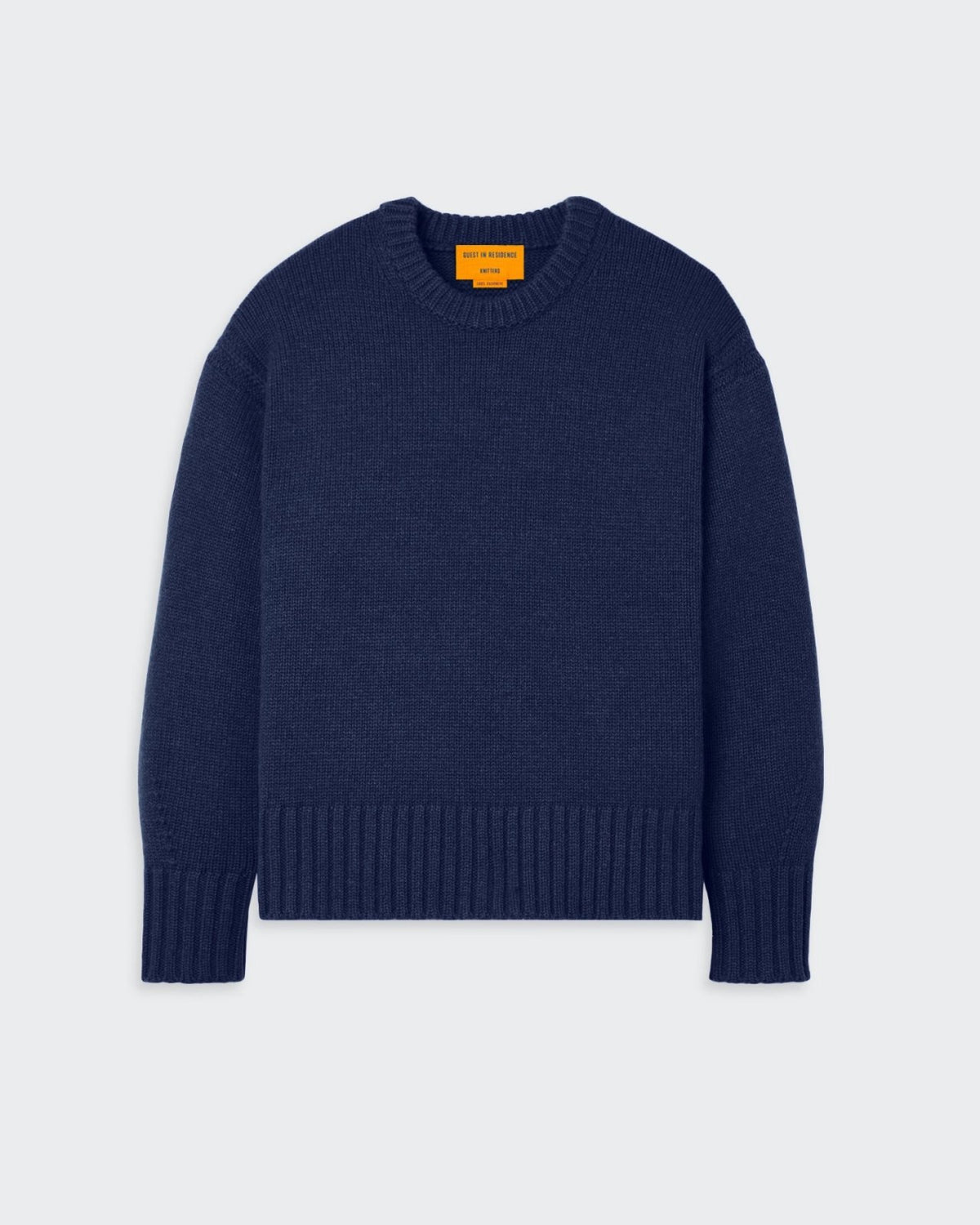 Cozy crew-neck sweater in midnight blue with tuck stitch detail around the arms and shoulders.