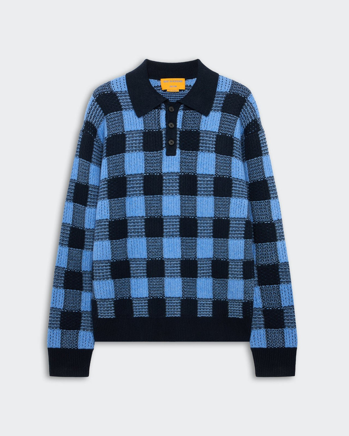 Blue and black checkered knit sweater with a collar and three black buttons on the front, displayed on a light gray background.