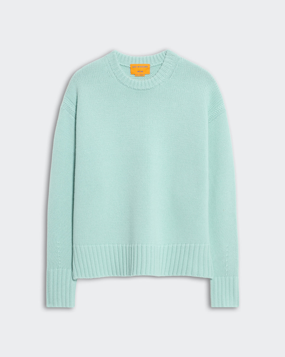 Light blue oversized women's crew neck sweater with ribbed trim on neck, cuffs, and hem, side slit detail visible