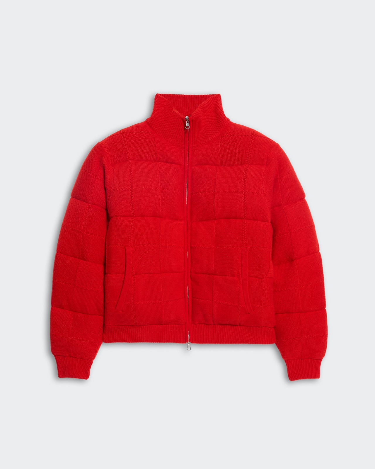 Red insulated quilted puffer jacket with square grid stitching, front pockets, ribbed turtleneck, and zip closure.