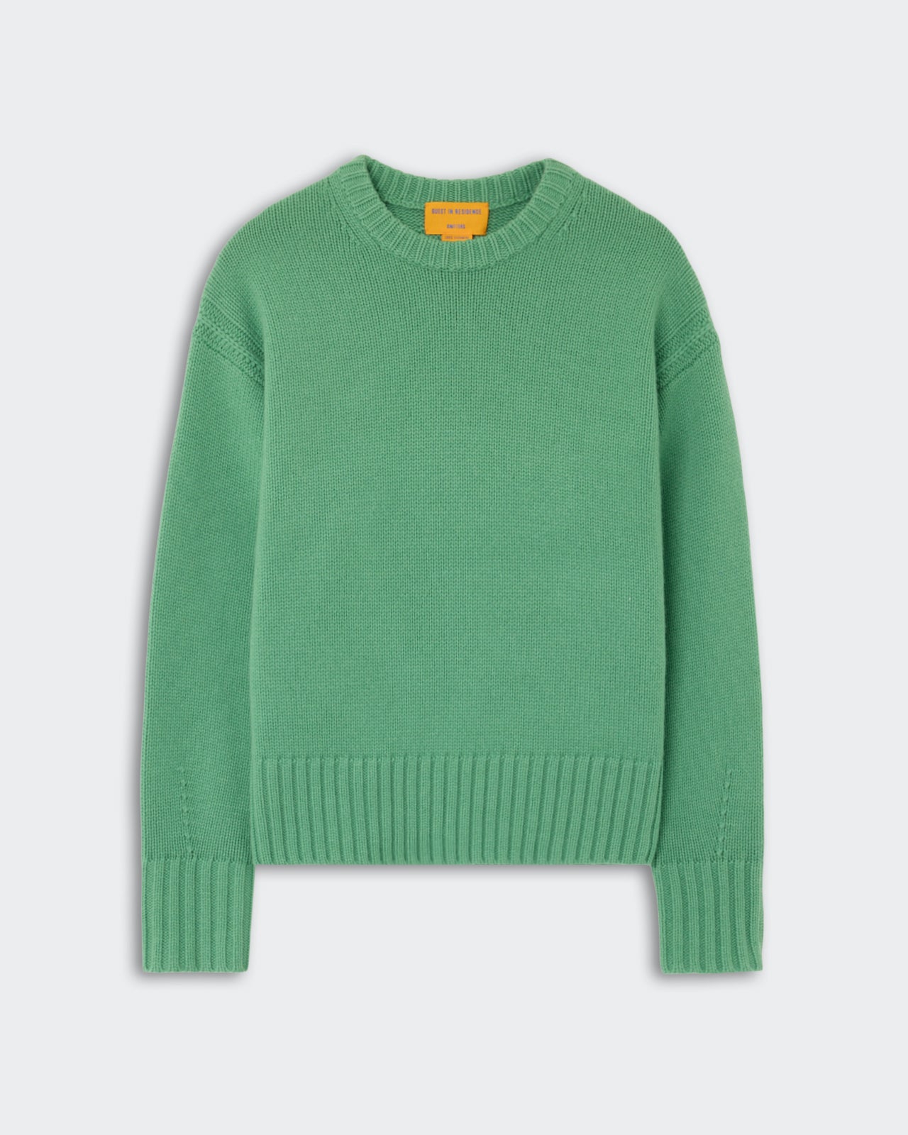 Green knitted long-sleeve sweater with a ribbed crew neckline, cuffs, and hem laid flat on a light background.