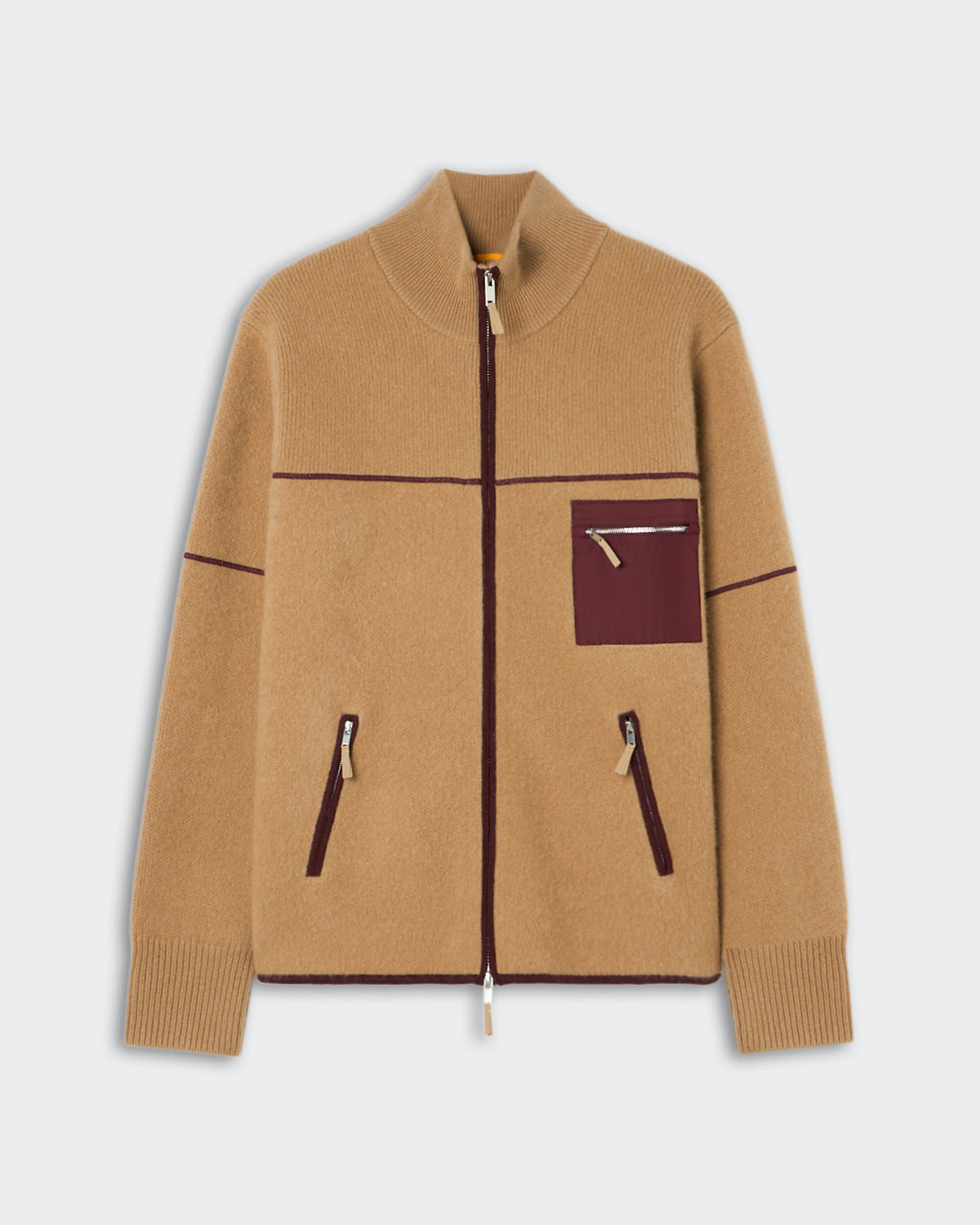 Beige zip-up jacket with dark brown trim, featuring a high collar, ribbed cuffs, two vertical zippered pockets at the front, and one small zippered chest pocket.