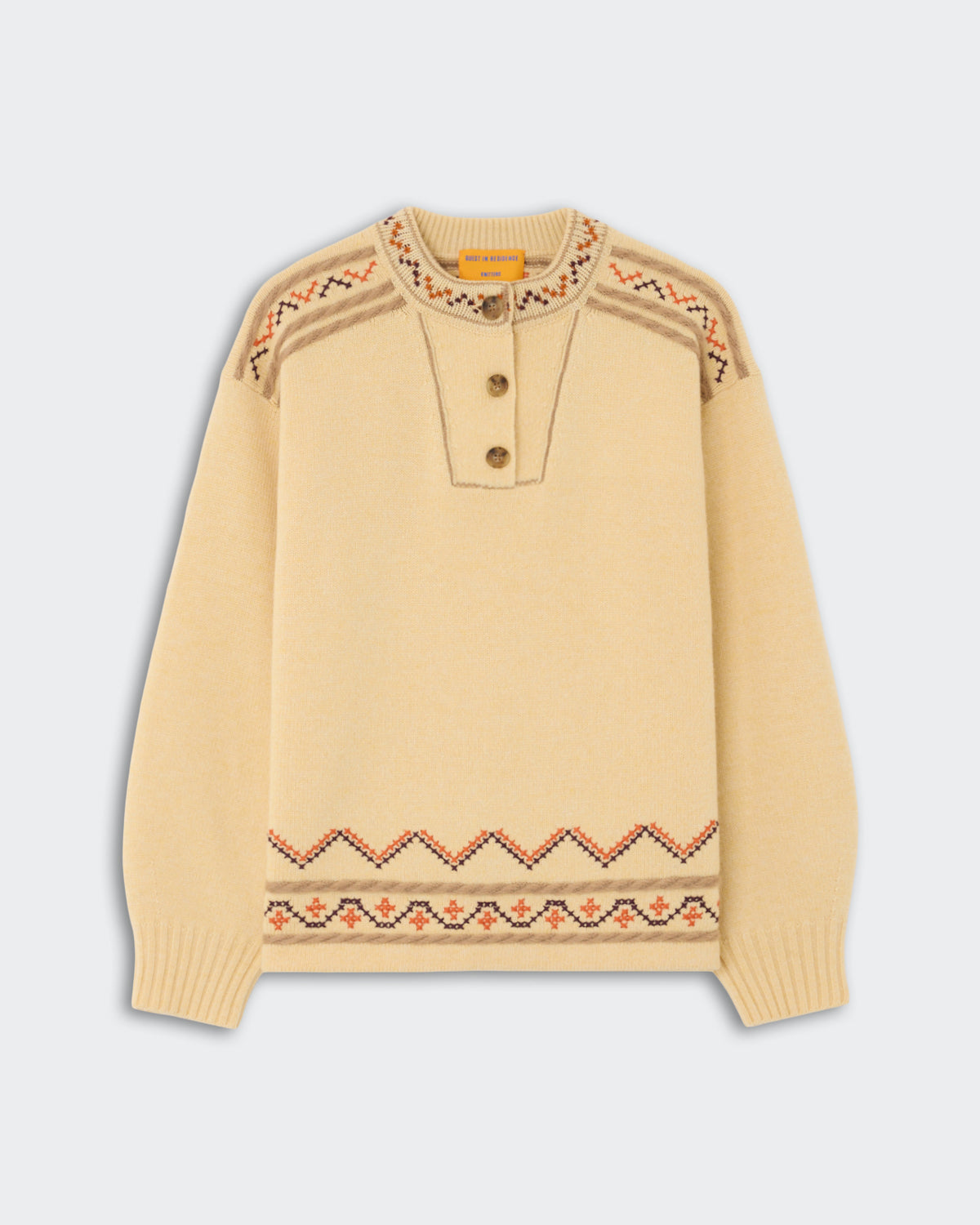 Fisherman Henley - Butter in soft yellow with buttoned placket and patterned detailing on shoulders and hem, showcasing a cozy and stylish knit design.