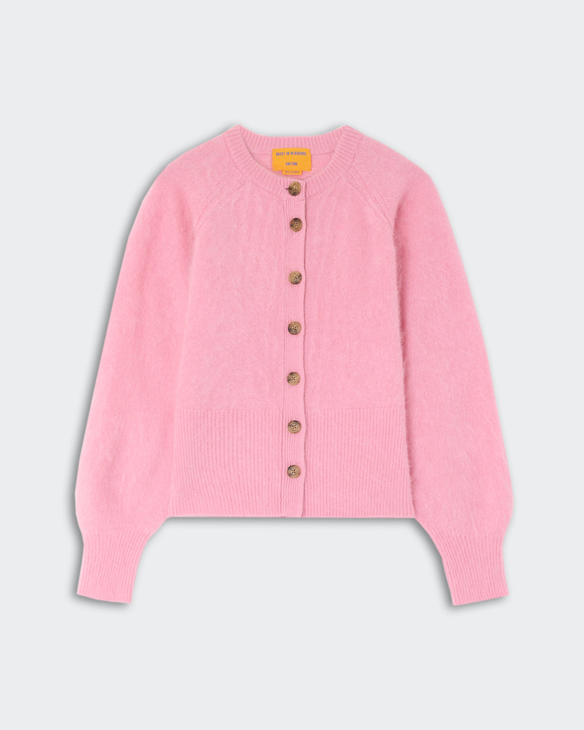 Soft pink long-sleeve cardigan with a round neckline and a front button closure featuring seven brown buttons, displayed on a light background.