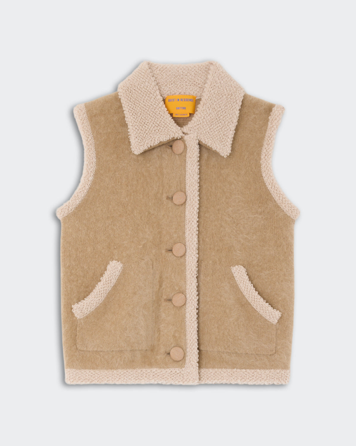 Beige sleeveless sherpa vest with button closure, large collar, and two front pockets against a light gray background.