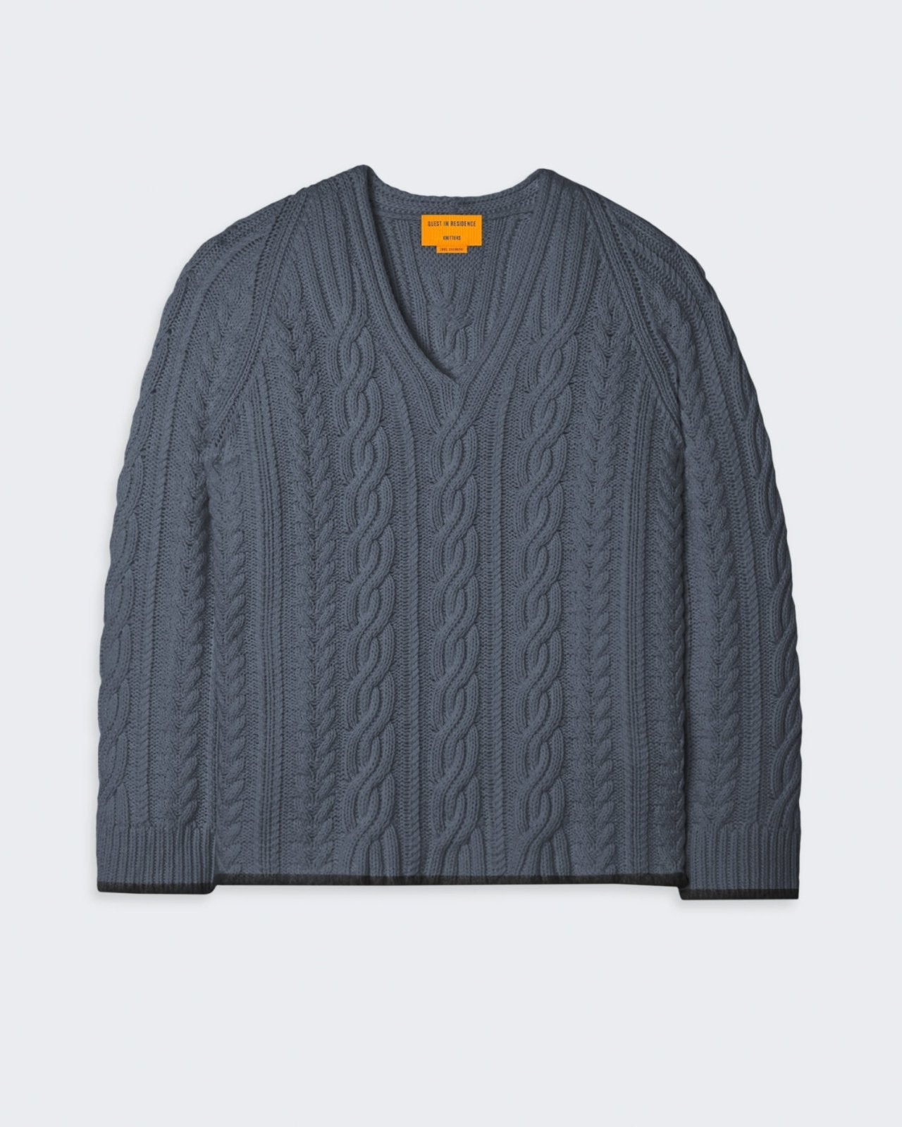 Cable knit charcoal gray sweater with a relaxed, oversized fit.