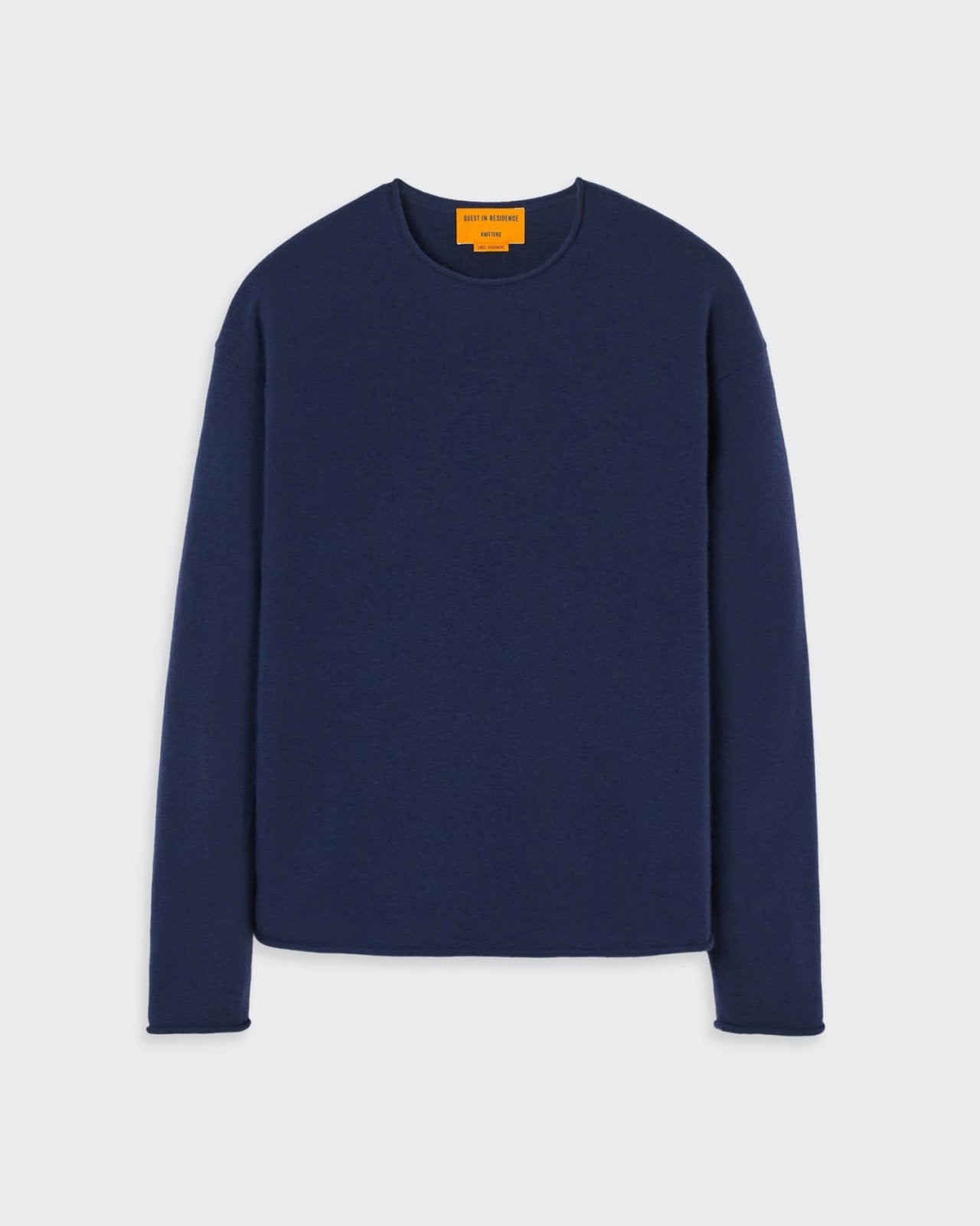 Men's oversized navy blue cashmere crew neck sweater with dropped shoulders and curved hemline.