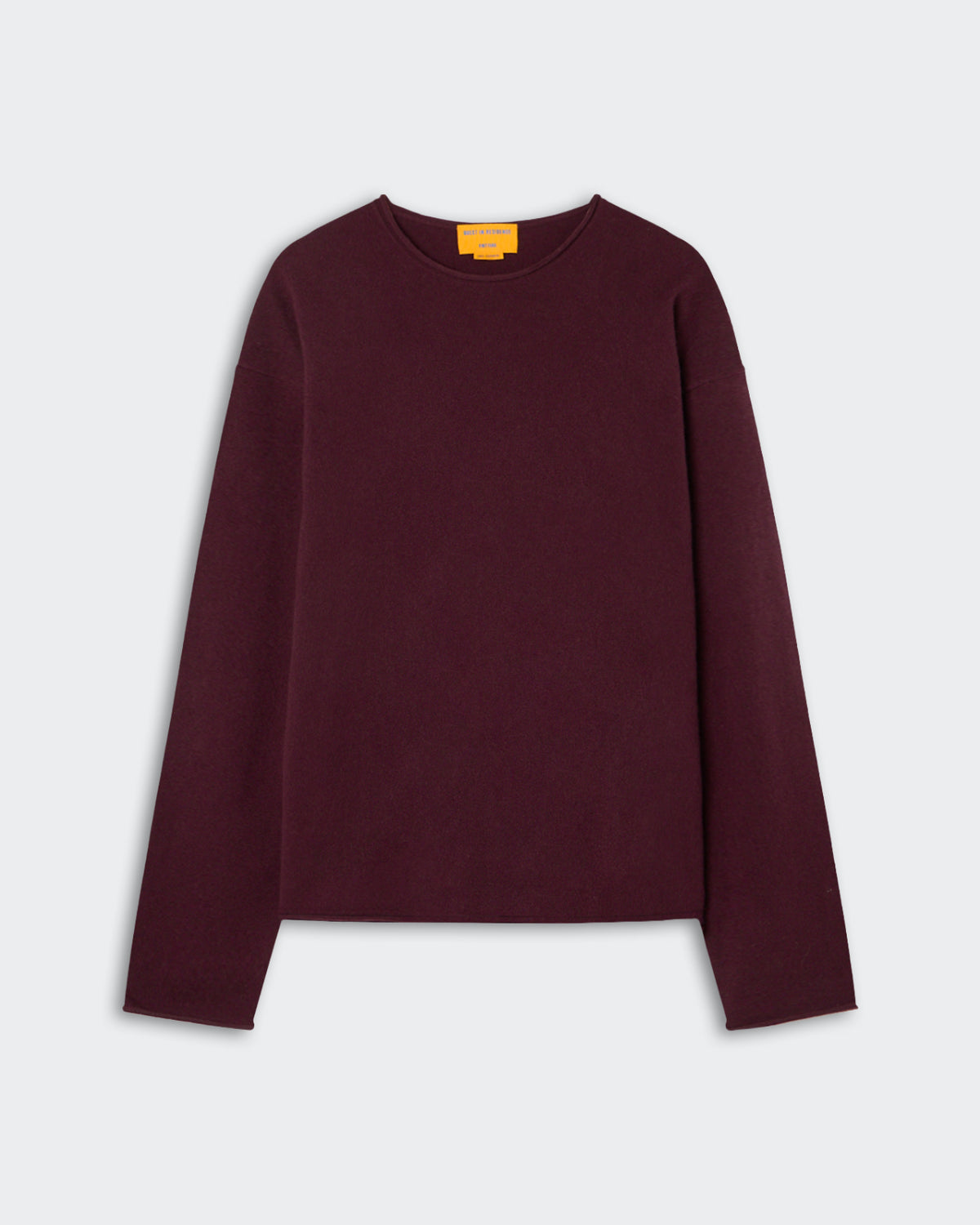 Long-sleeve crew neck sweater in dark burgundy color laid flat on a light gray background with a small yellow label inside the neckline.