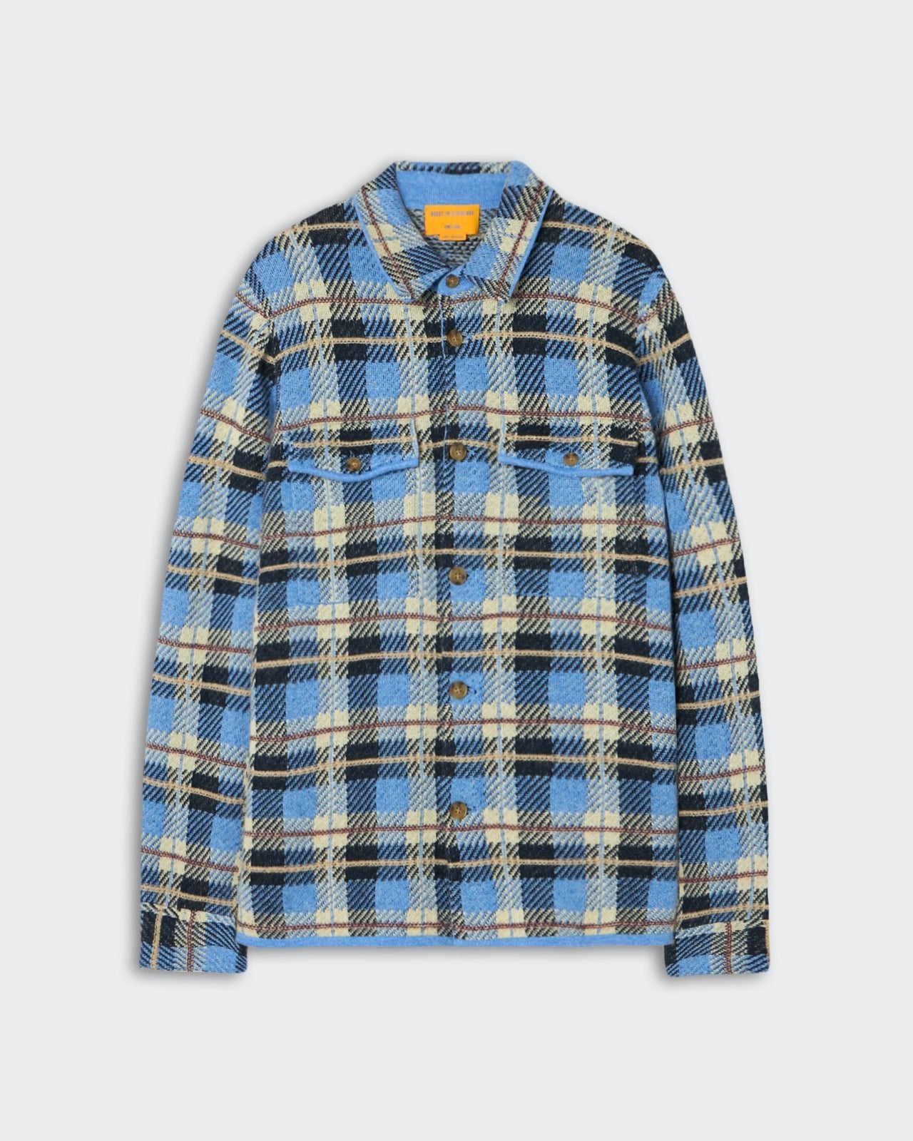 Blue, black, and beige plaid long-sleeve shirt jacket with button front and two chest pockets, displayed on a light gray background.