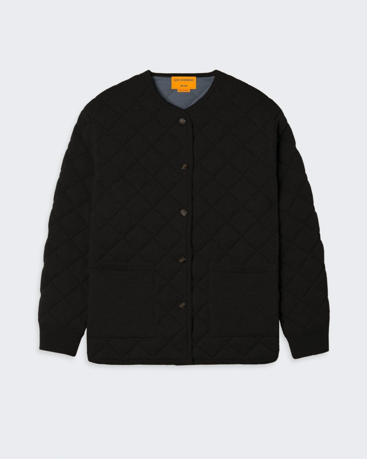 Quilted liner jacket in cashmere blend, black color, with snap front closure, two front patch pockets, rib sleeve trim, and curved hem.