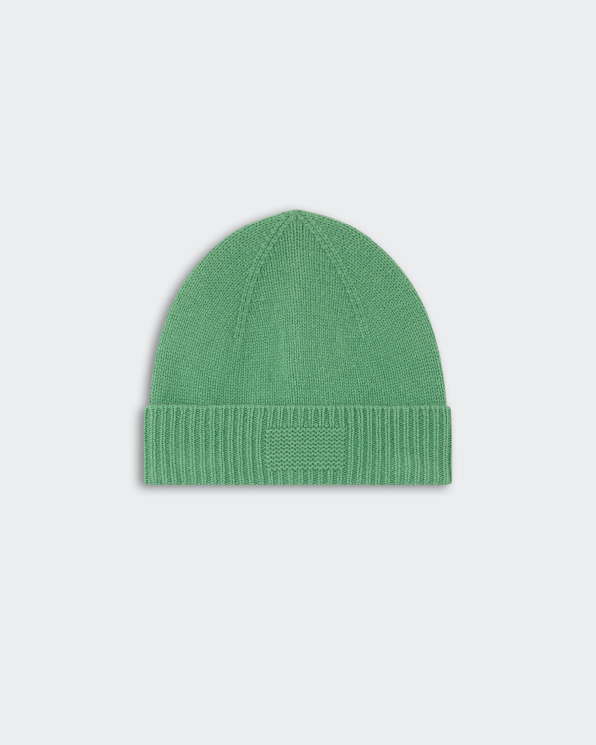 Rib Cuff Beanie - Highland in soft green knit with a folded ribbed cuff and a subtle rectangular patch on the front, styled for warmth and casual wear.