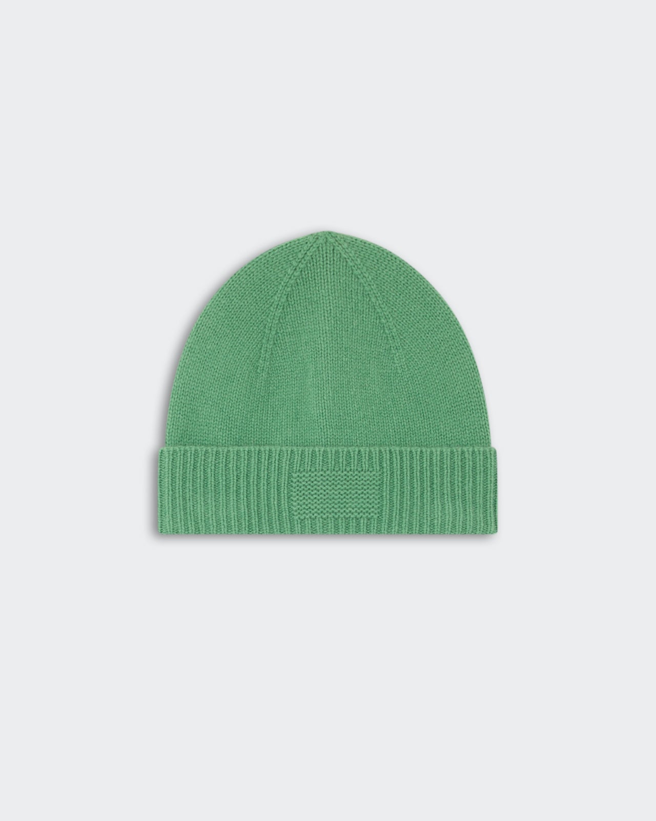 Rib Cuff Beanie - Highland in soft green knit with a folded ribbed cuff and a subtle rectangular patch on the front, styled for warmth and casual wear.