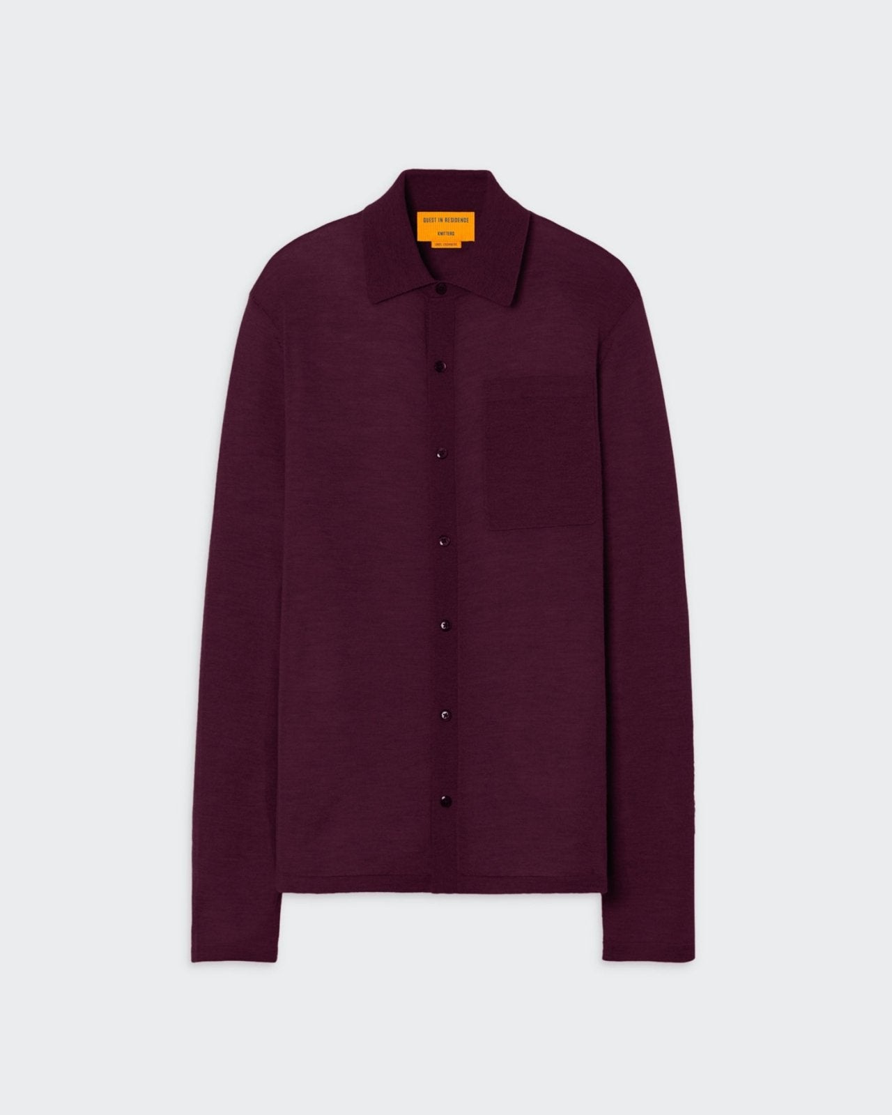 A maroon button-down women's shirt with a collar, featuring front patch pocket and branding at the center back neck.