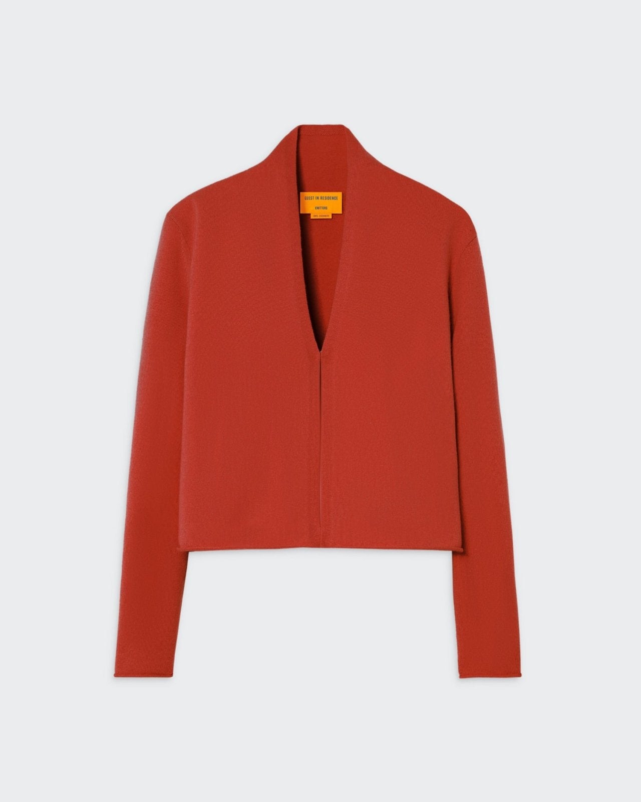 Casual red cardigan with shawl collar and hook-and-eye closure, showcasing clean design and premium cashmere construction.