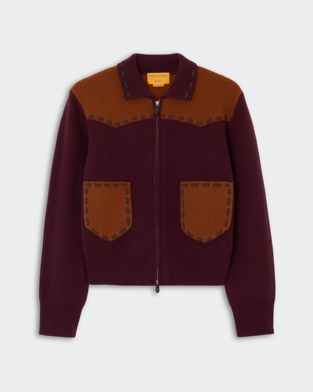 Saddle Up! Jacket - Fig/Burnt Sienna" featuring a zip-up front, contrasting burnt sienna yoke and pockets on a fig-colored knit fabric, designed with ribbed cuffs and hem.