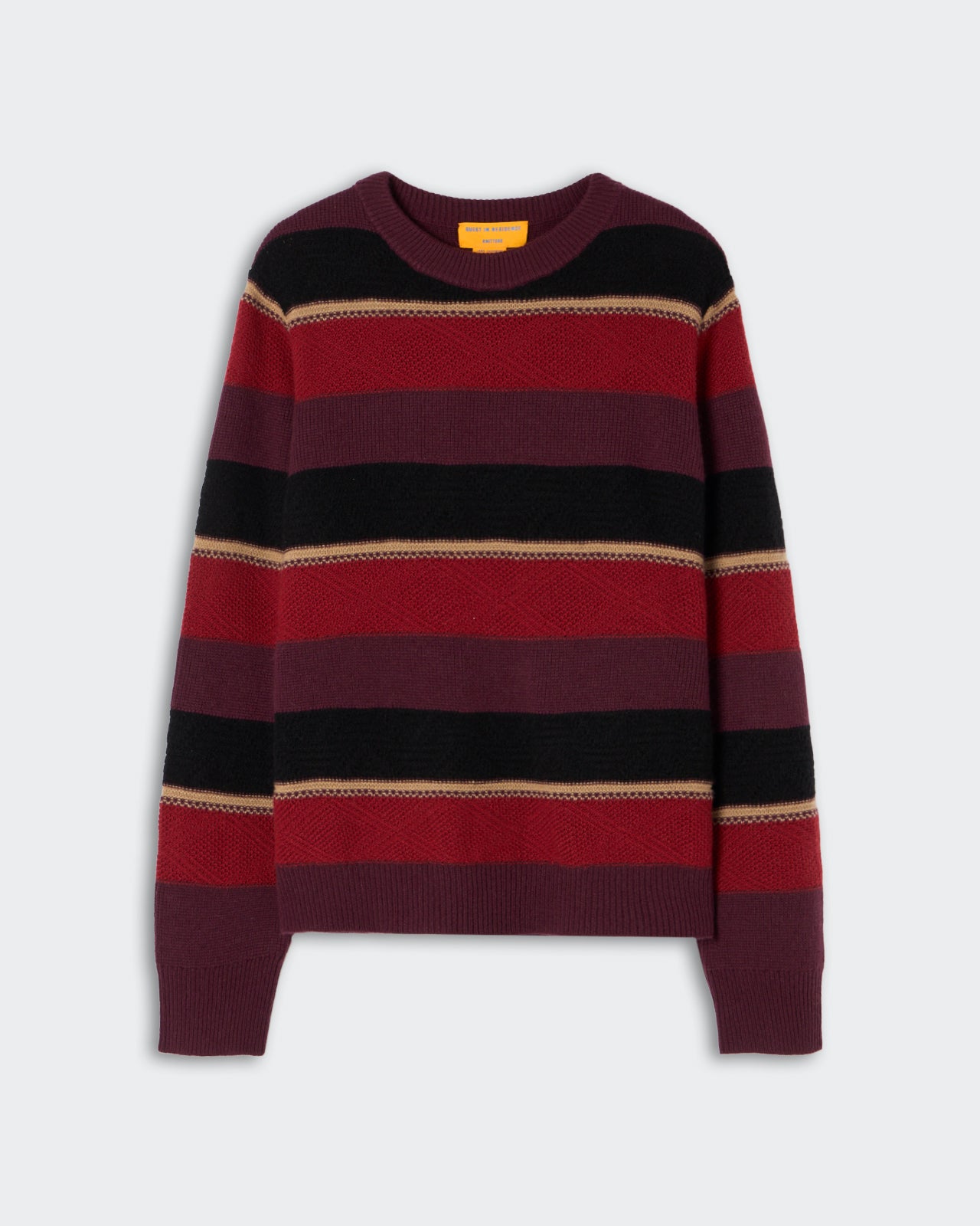 Knit sweater with horizontal stripes in shades of burgundy, red, black, and beige, featuring a crew neck and long sleeves against a plain background.