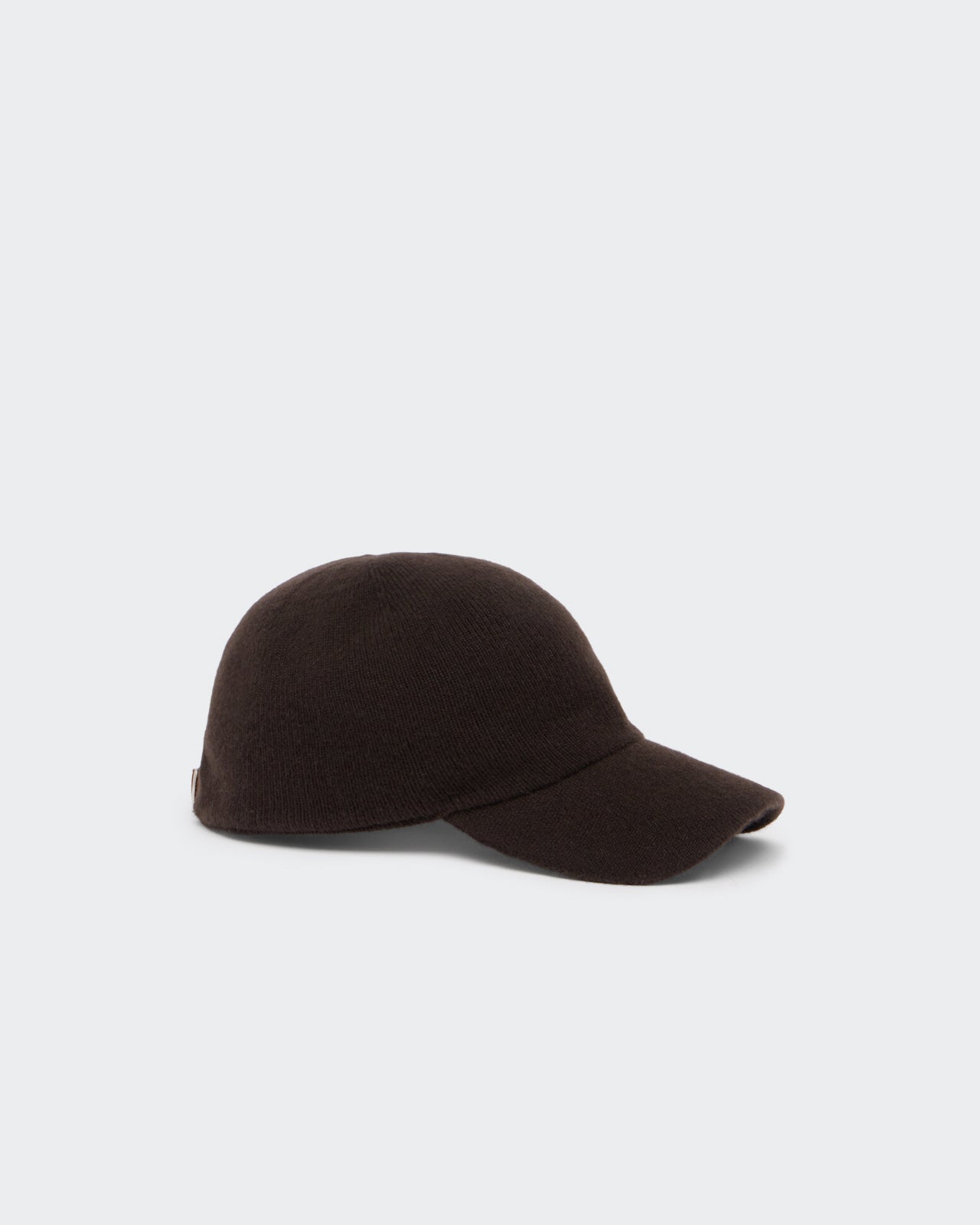 The Baseball Cap - Carmine/Burnt Cocoa displayed on a plain background featuring a rich dark brown knitted texture with a curved brim and a sleek, minimalist design.